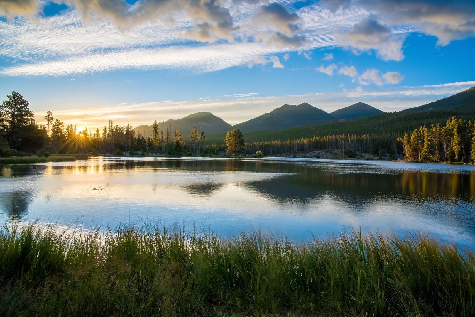 Sunrise over a mountain lake with pine trees HD Wallpaper