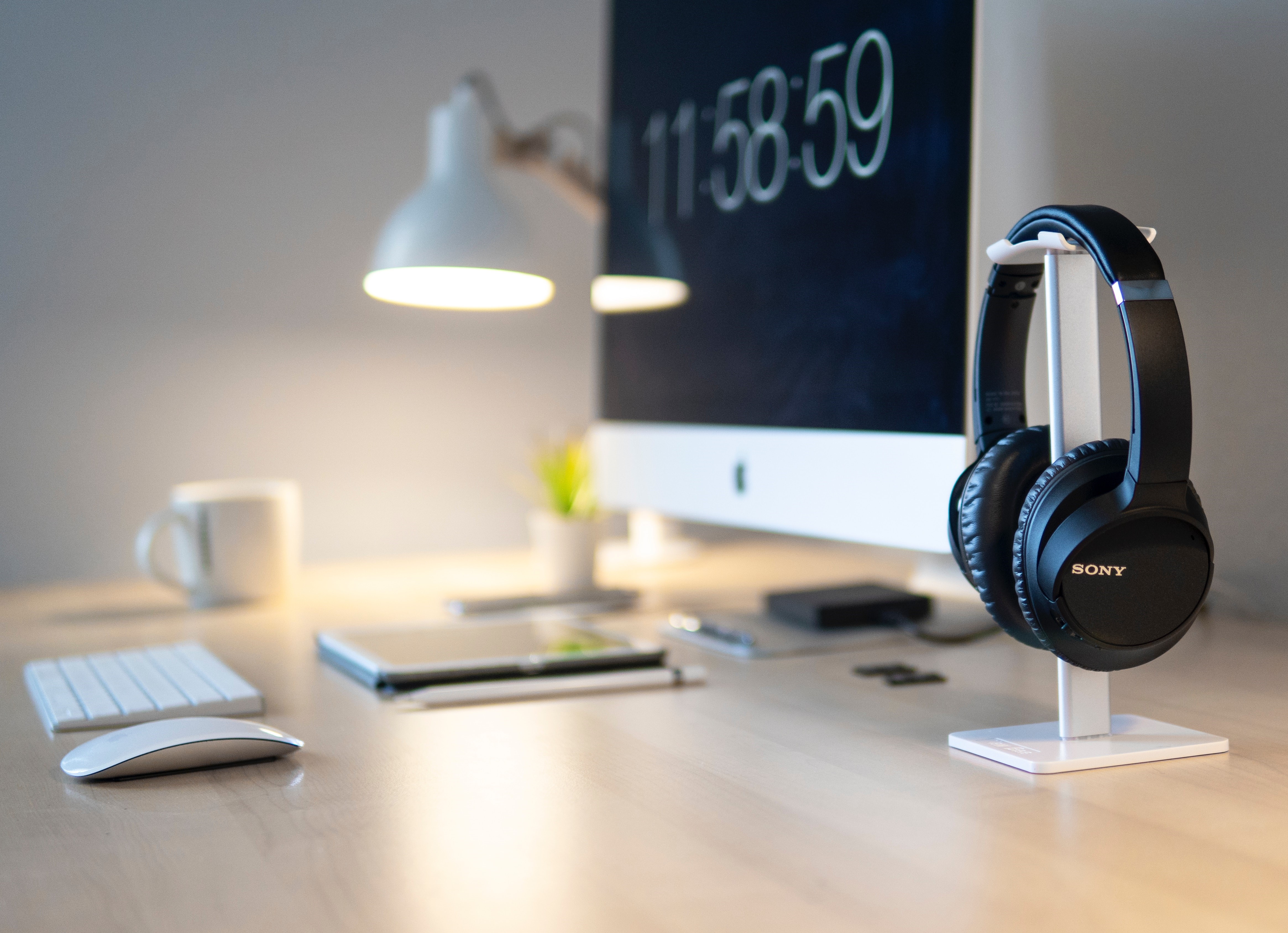 Sony headphones on a desk with a computer HD Wallpaper