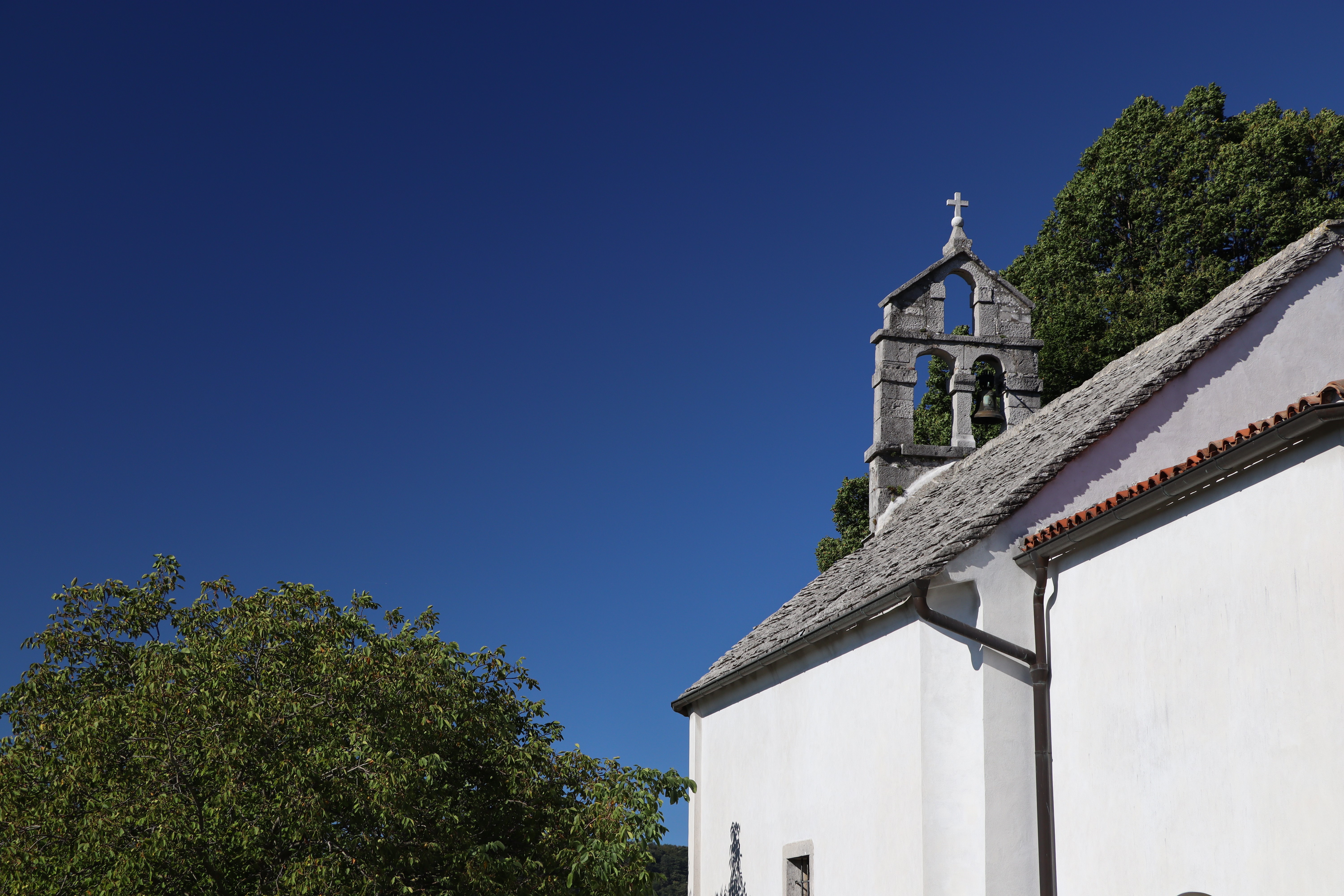 Church bell tower and roof against blue sky HD Wallpaper