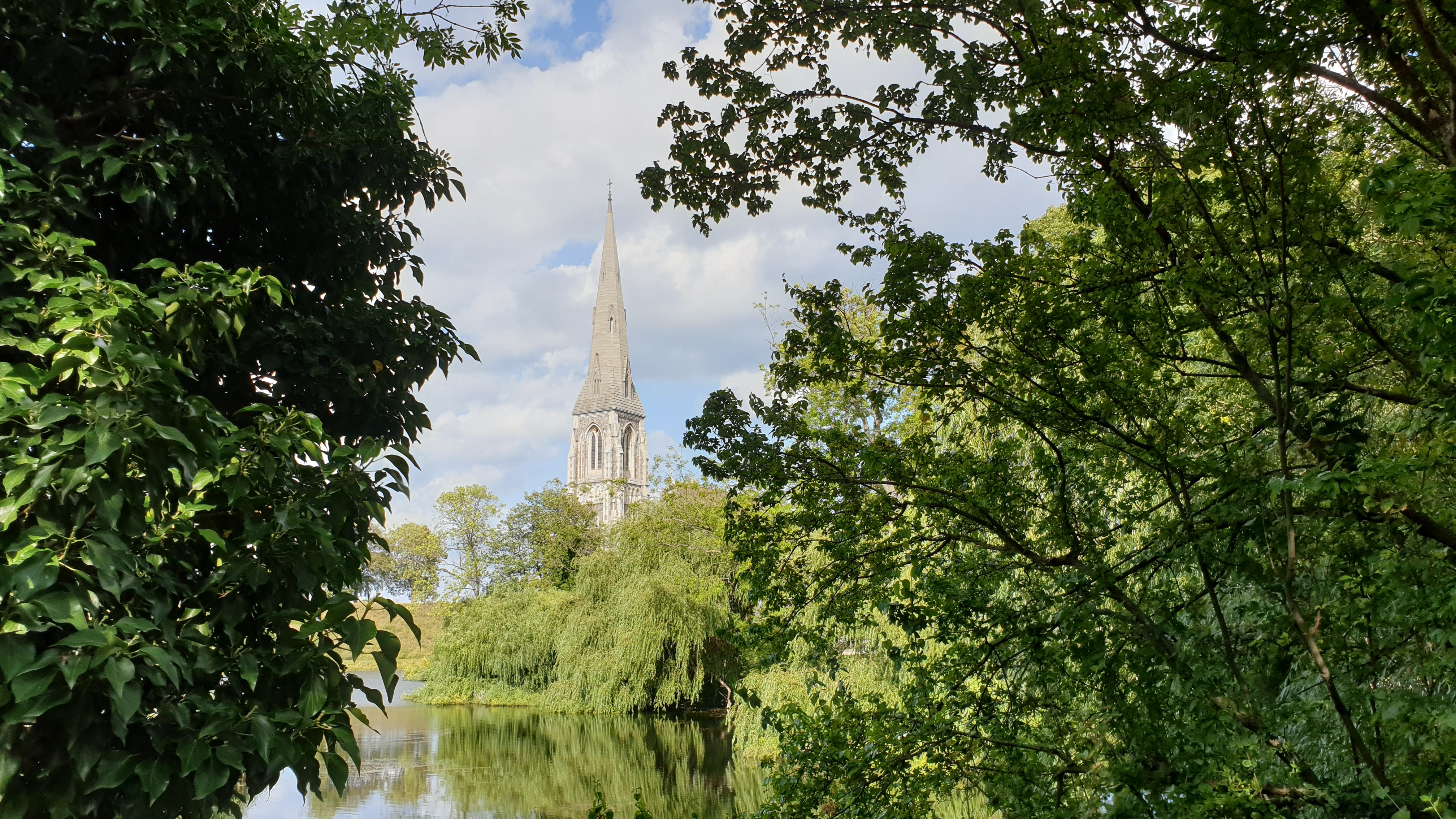 Church spire behind trees and pond HD Wallpaper