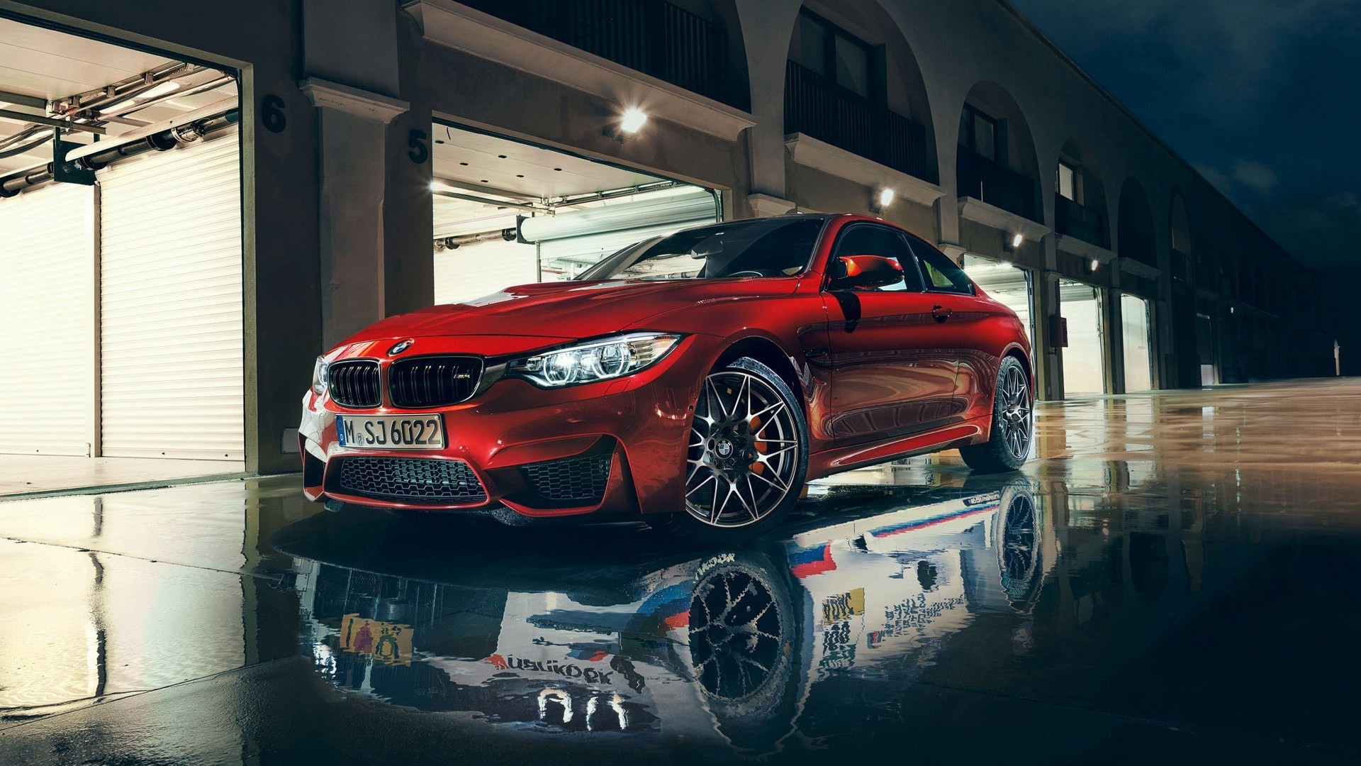 Red BMW M4 on wet ground with garage background HD Wallpaper