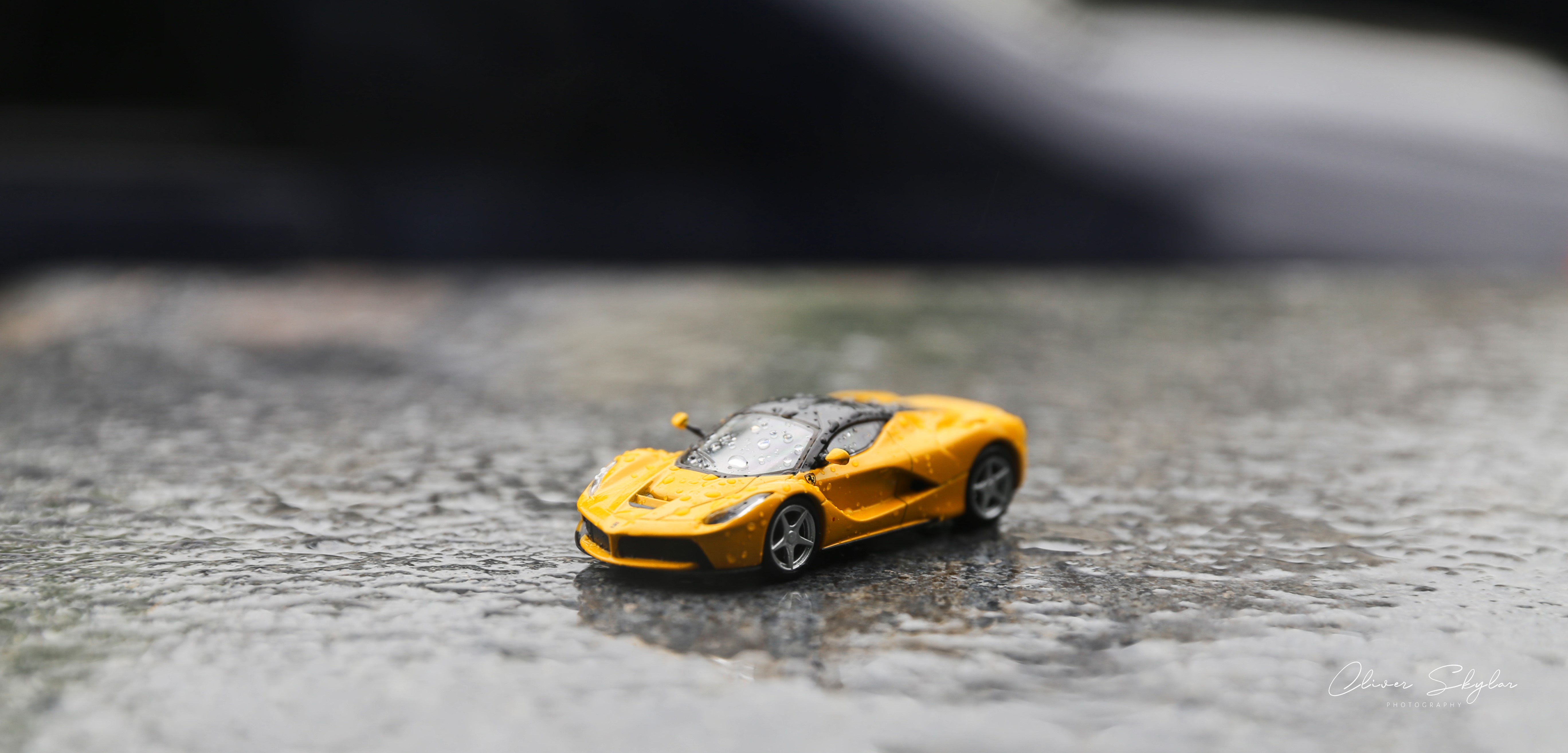 Yellow Ferrari LaFerrari toy car in rain HD Wallpaper