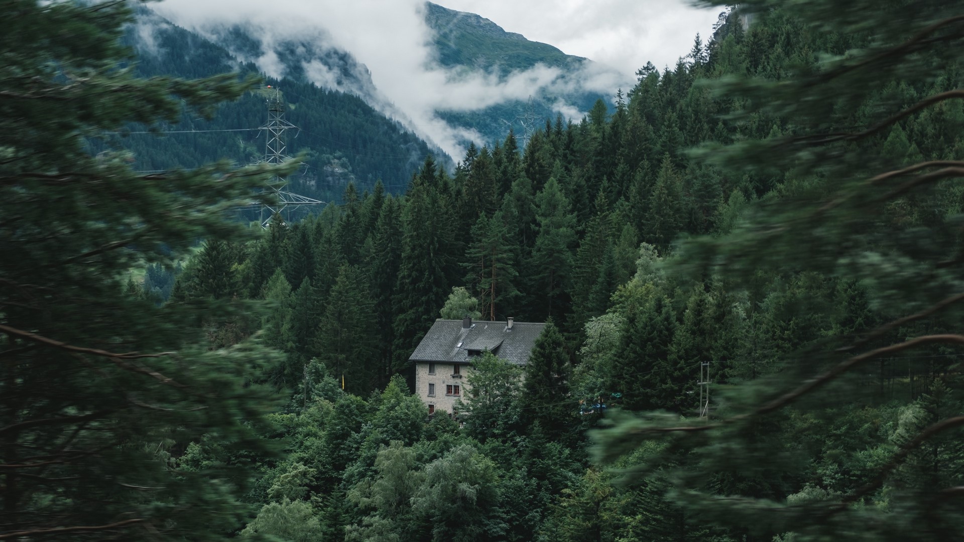 Building in a misty forest with mountains HD Wallpaper