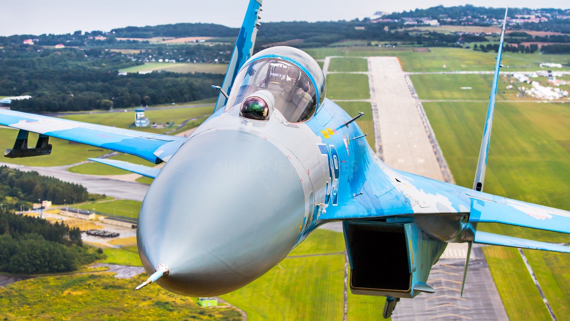 Sukhoi Su-27 military aircraft flying over runway HD Wallpaper
