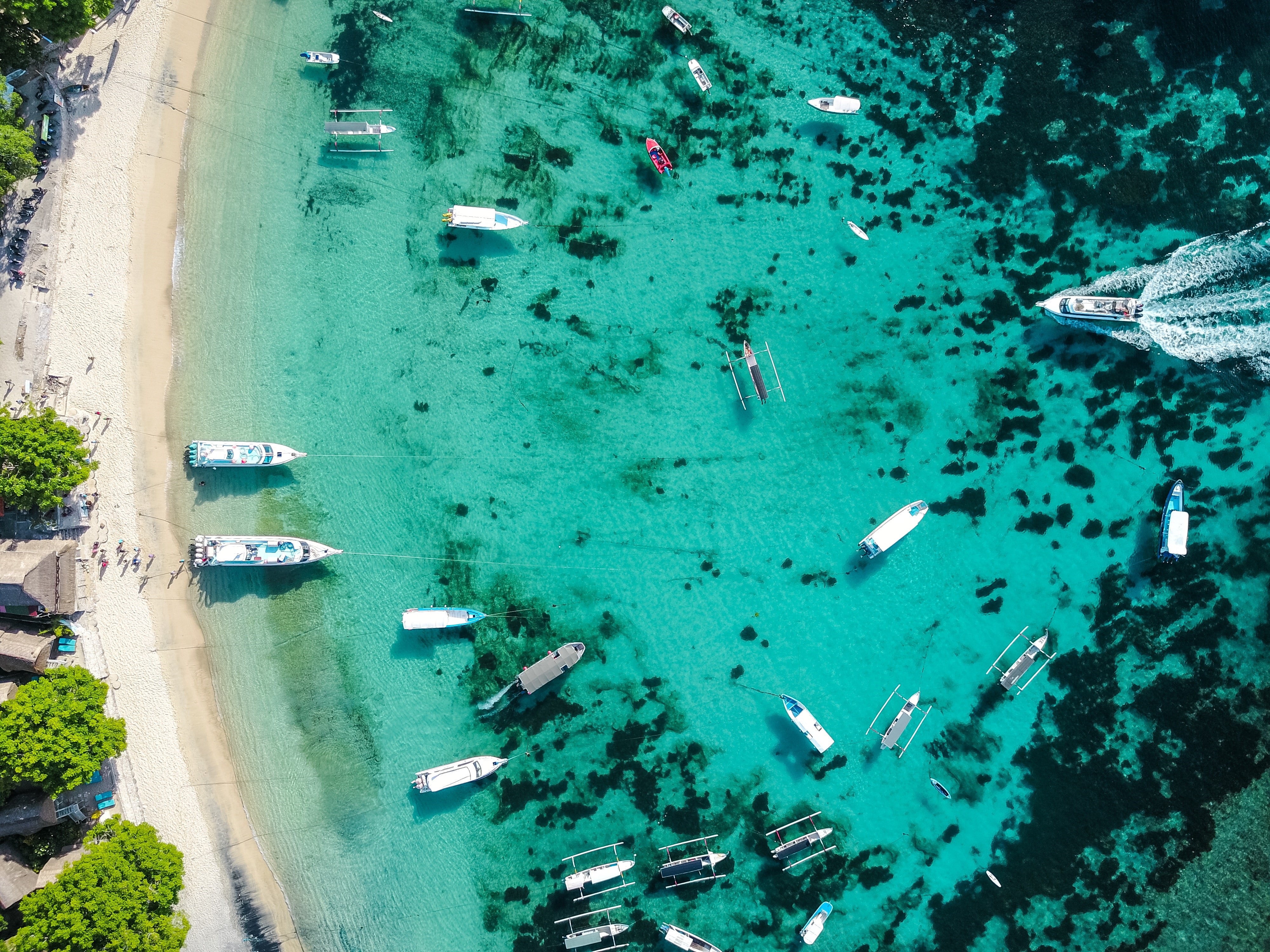 Aerial view of boats on a tropical beach with turquoise water HD Wallpaper