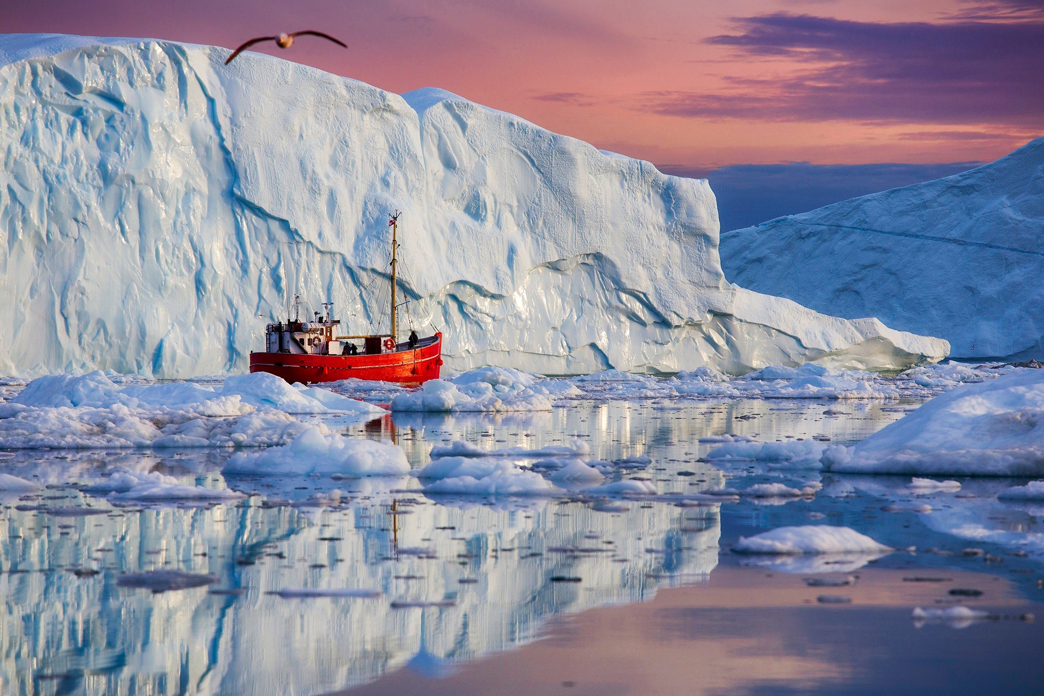 Red boat sailing near icebergs in Greenland HD Wallpaper