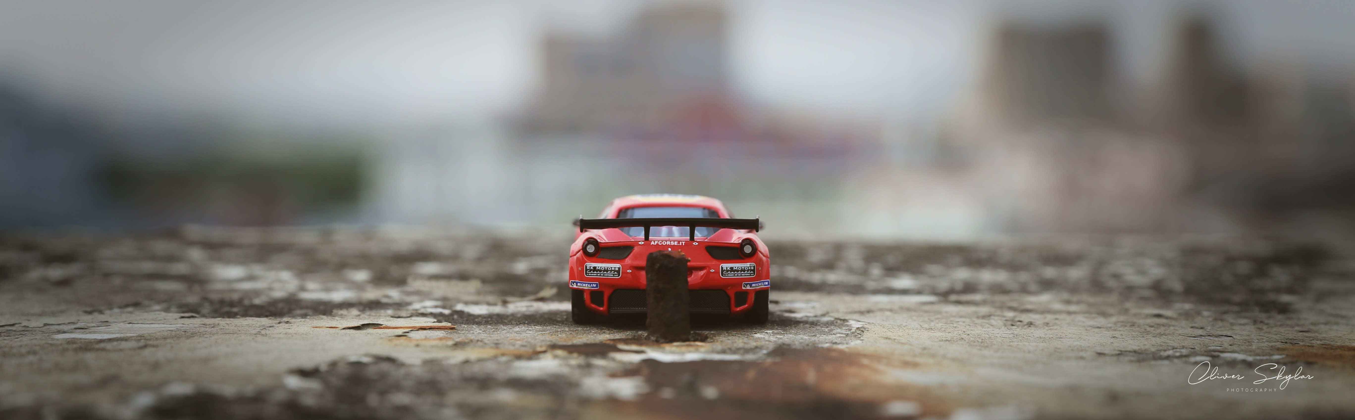 Red Ferrari 458 race car on textured surface HD Wallpaper