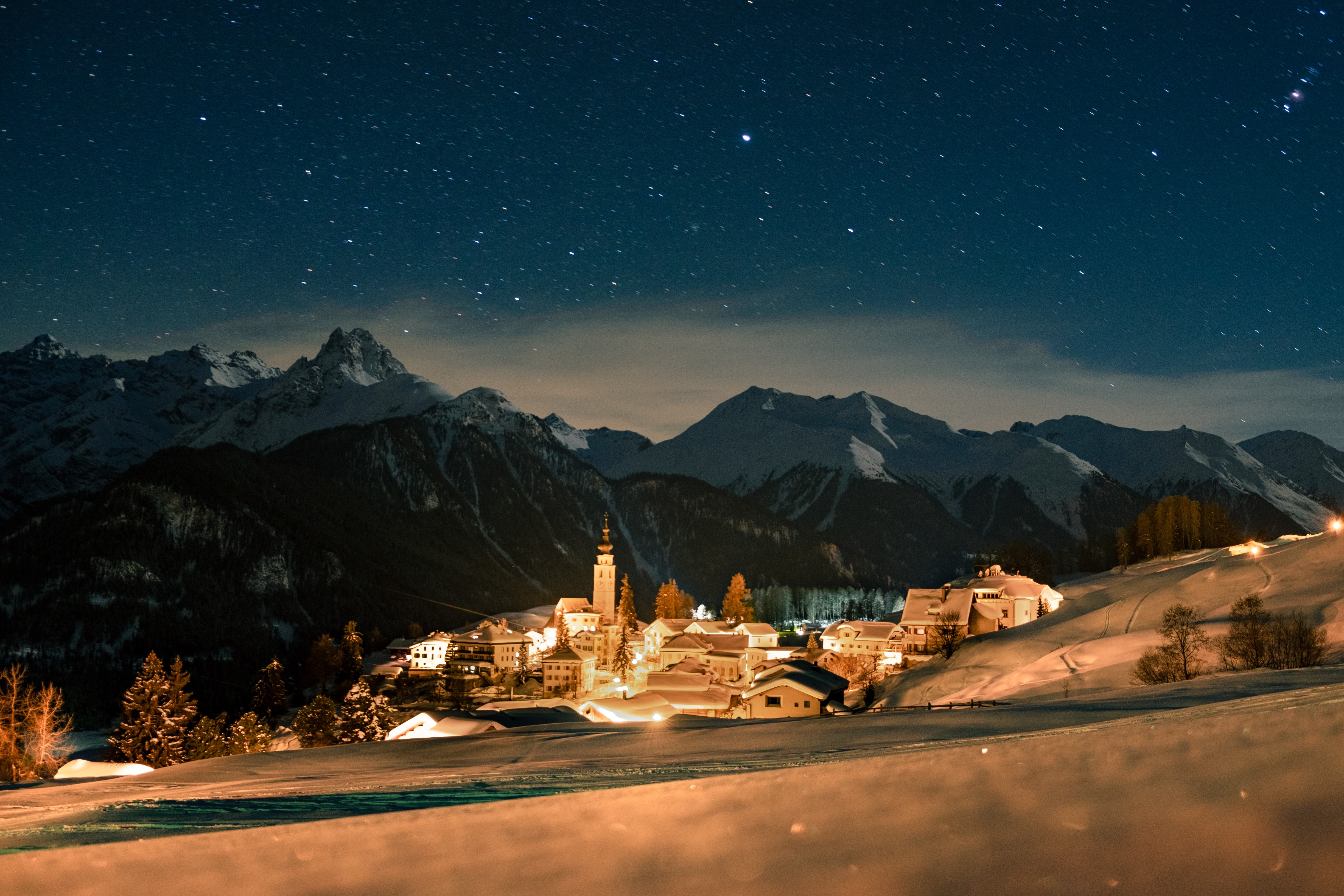 Winter village under starry sky in Switzerland HD Wallpaper