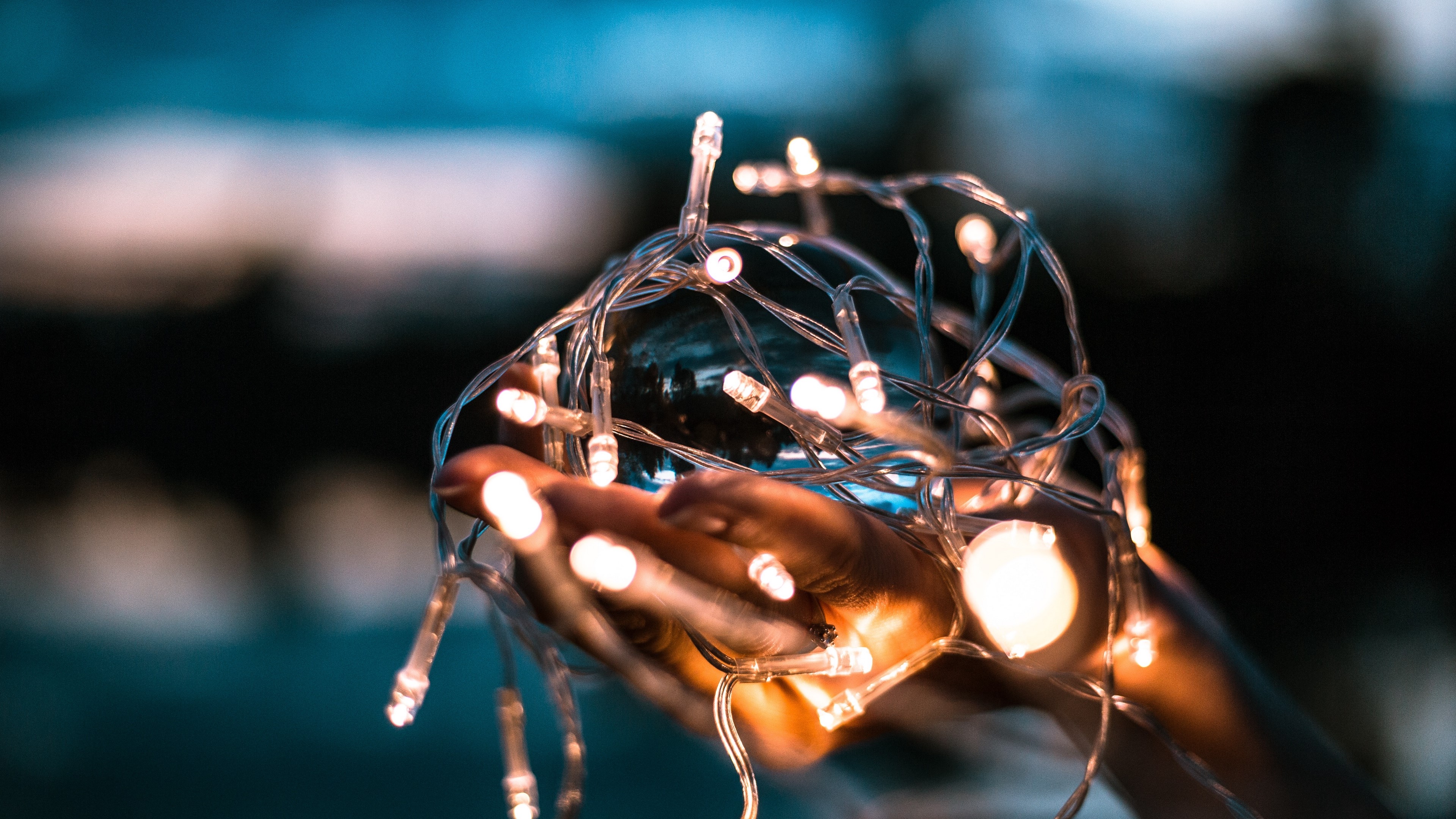 Hands holding fairy lights and a glass orb HD Wallpaper