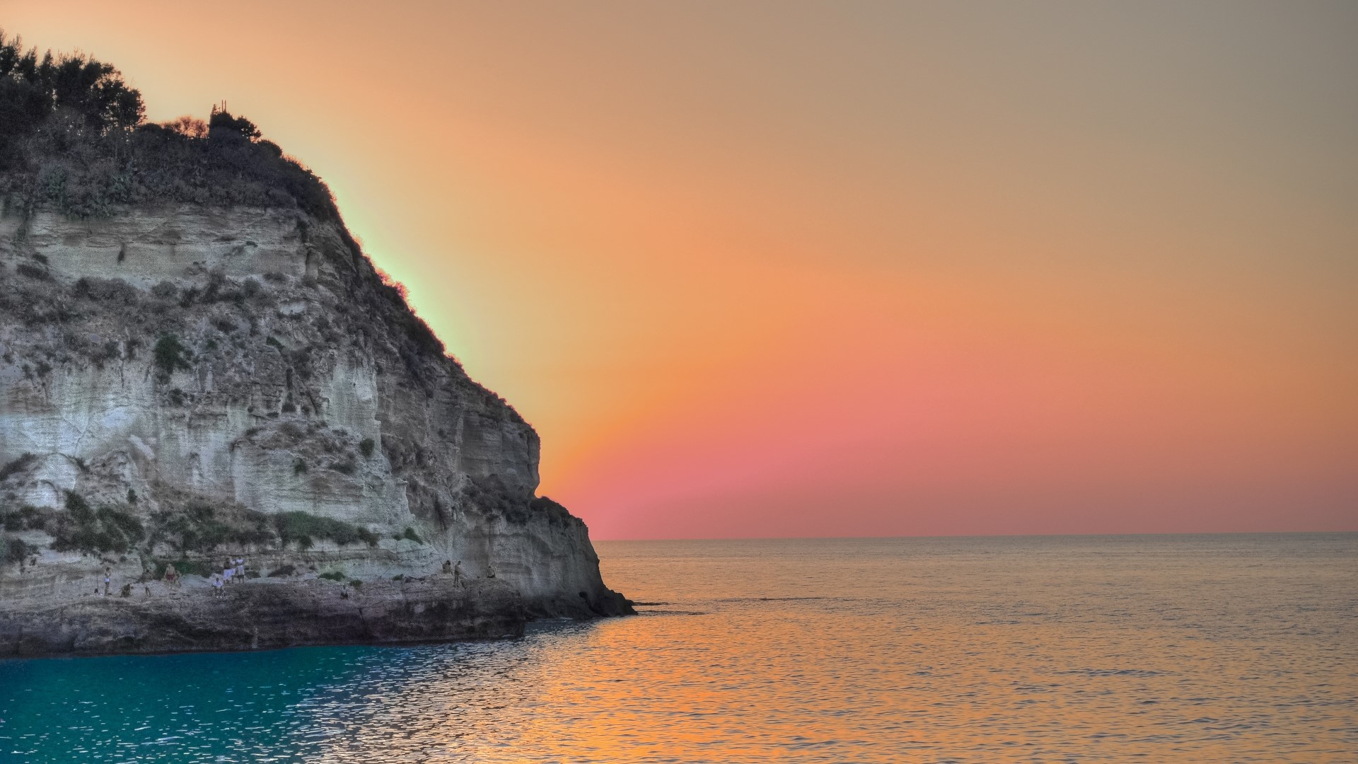 Cliff overlooking the sea at sunset in Tropea, Italy HD Wallpaper