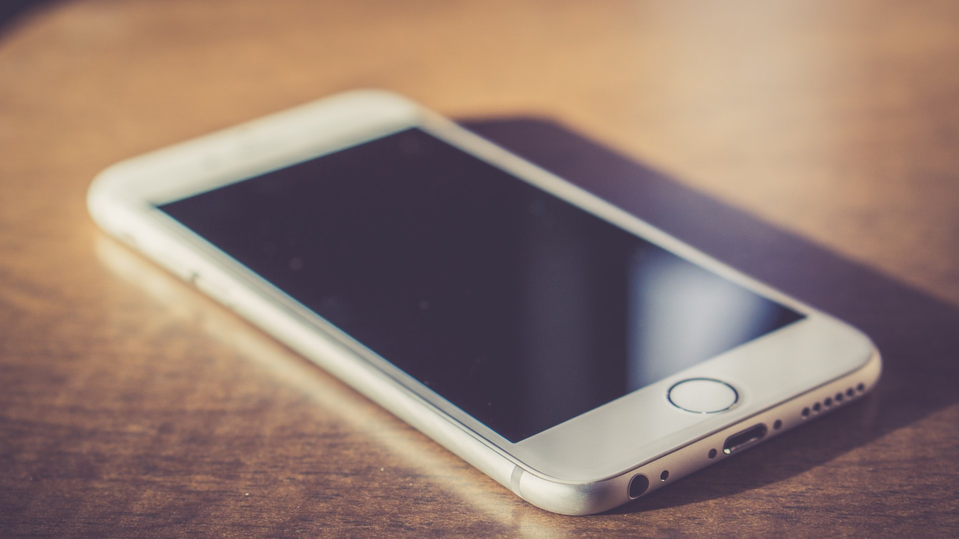 White iPhone 6 on a wooden table HD Wallpaper