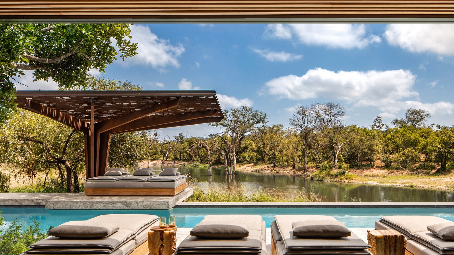 Luxury outdoor lounge area with swimming pool and lake view HD Wallpaper