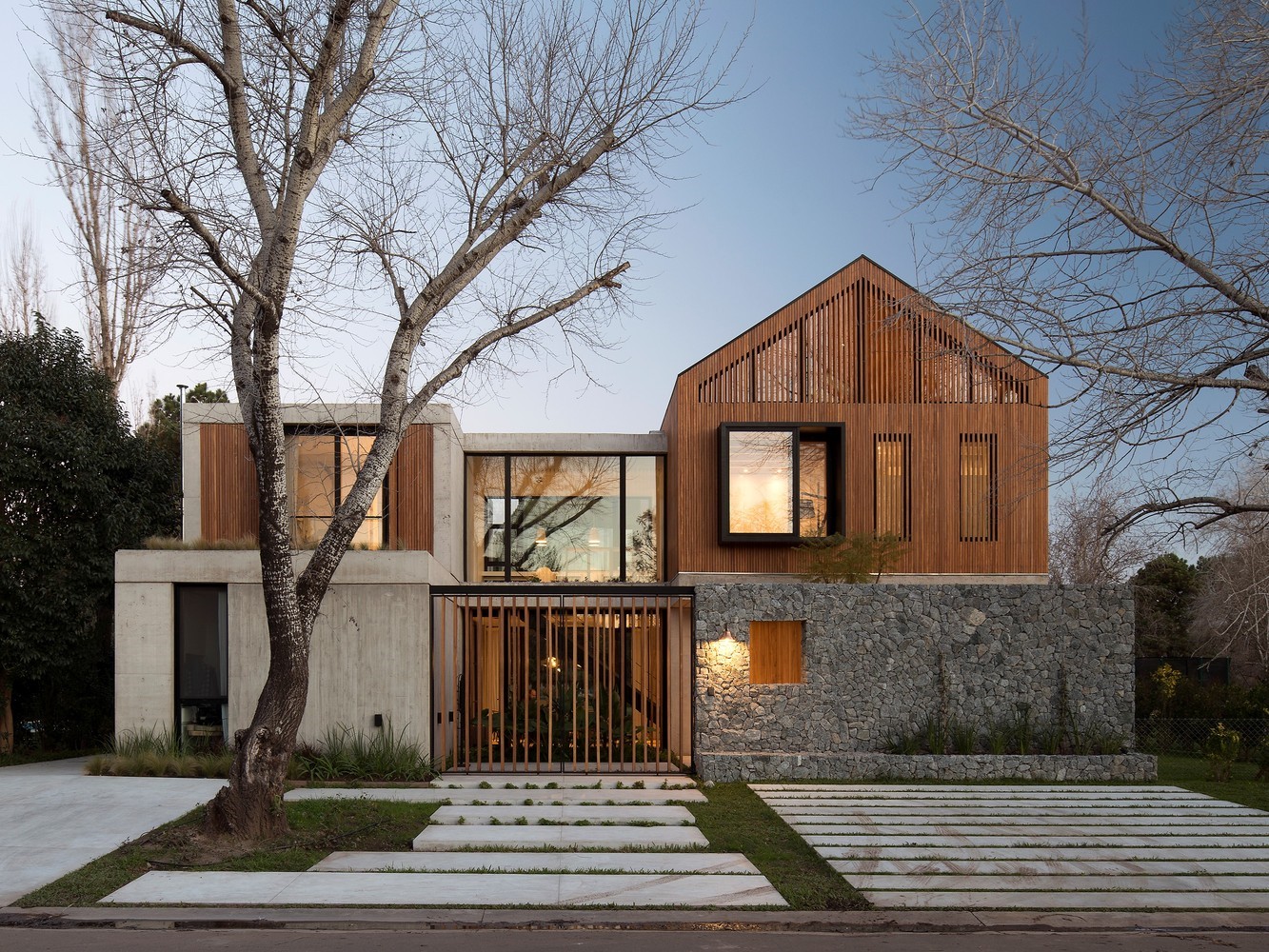 Modern concrete and wood house with stone wall HD Wallpaper
