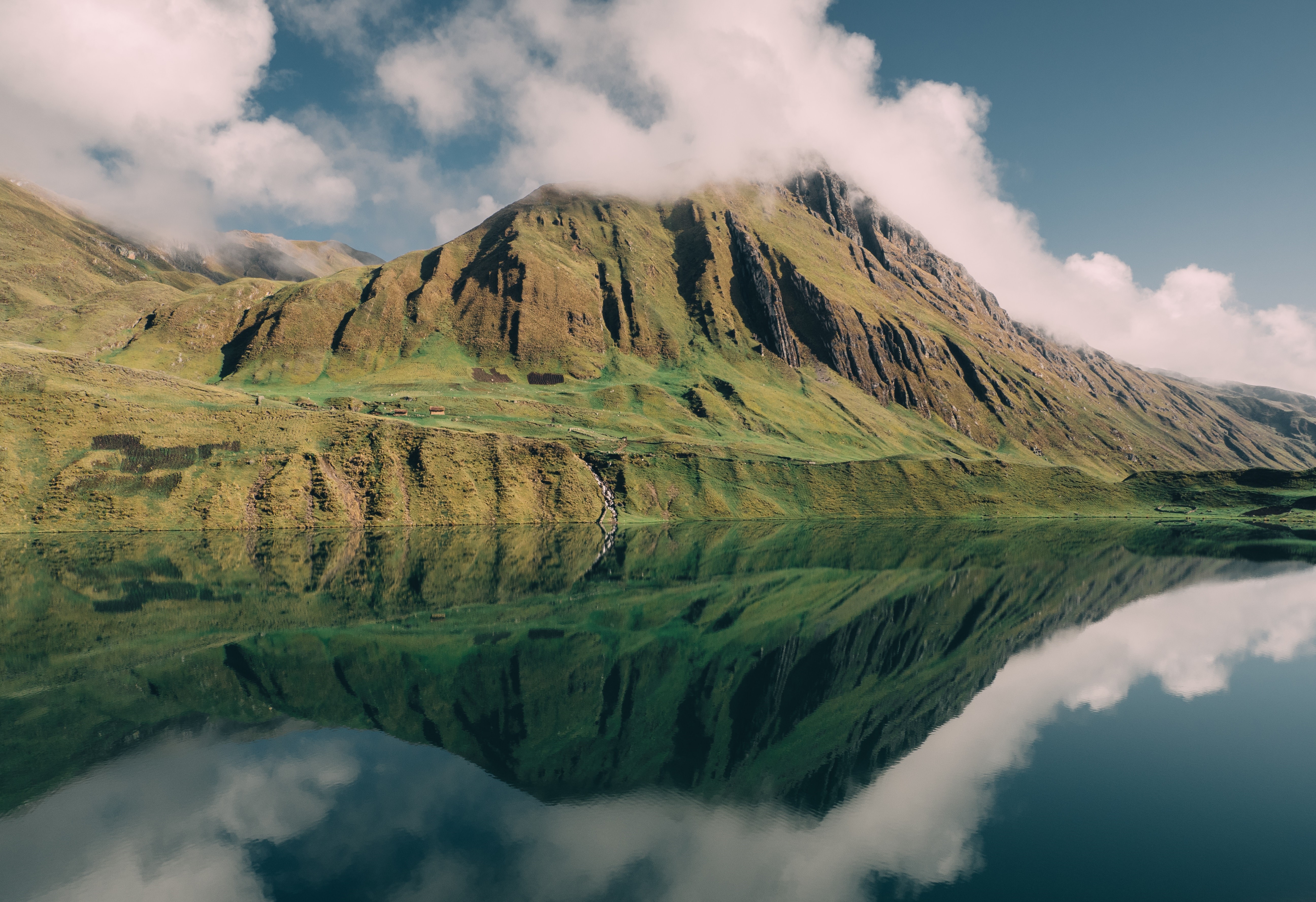Mountains reflected in a lake with clouds HD Wallpaper