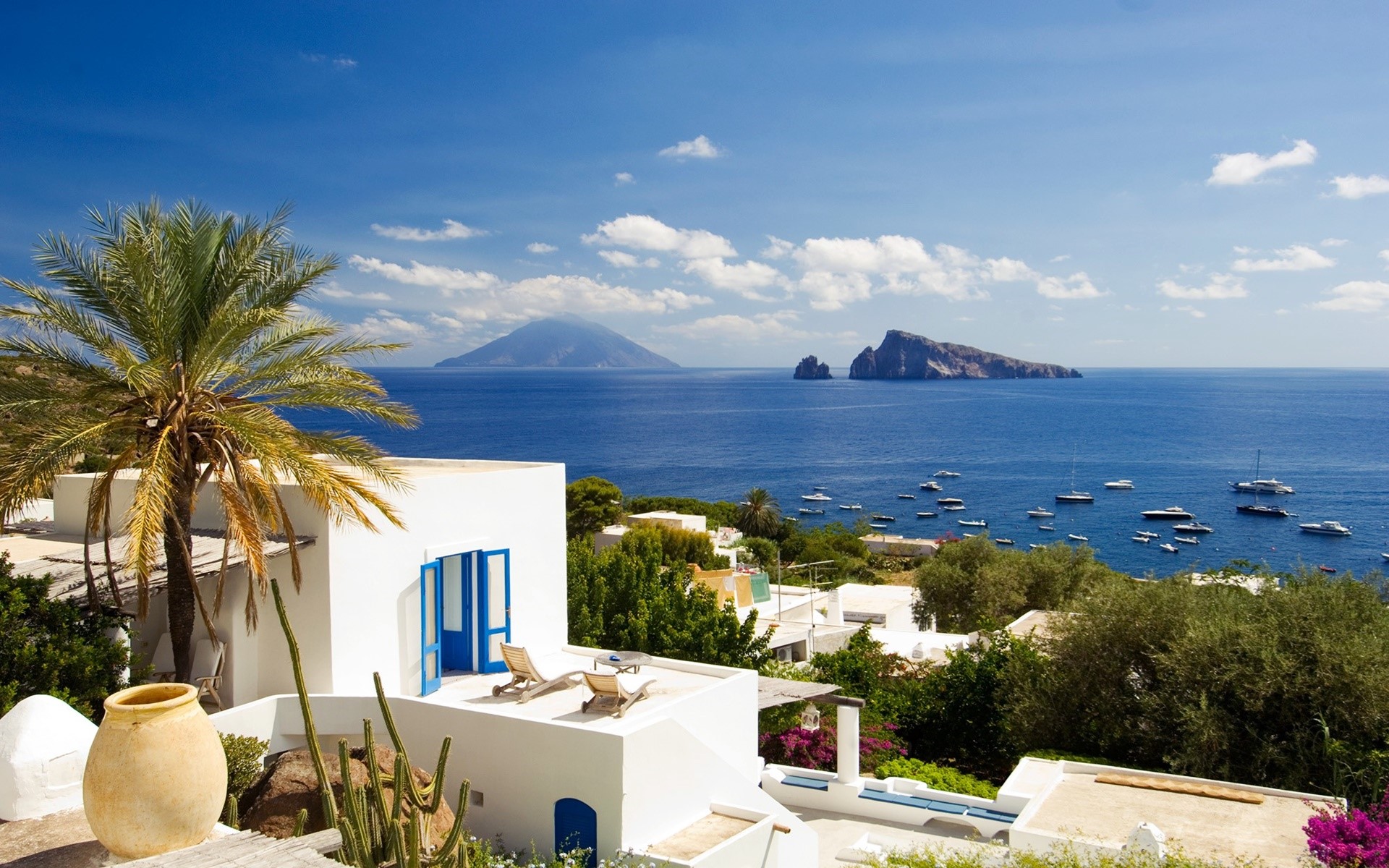White villa overlooking the sea with boats and islands HD Wallpaper