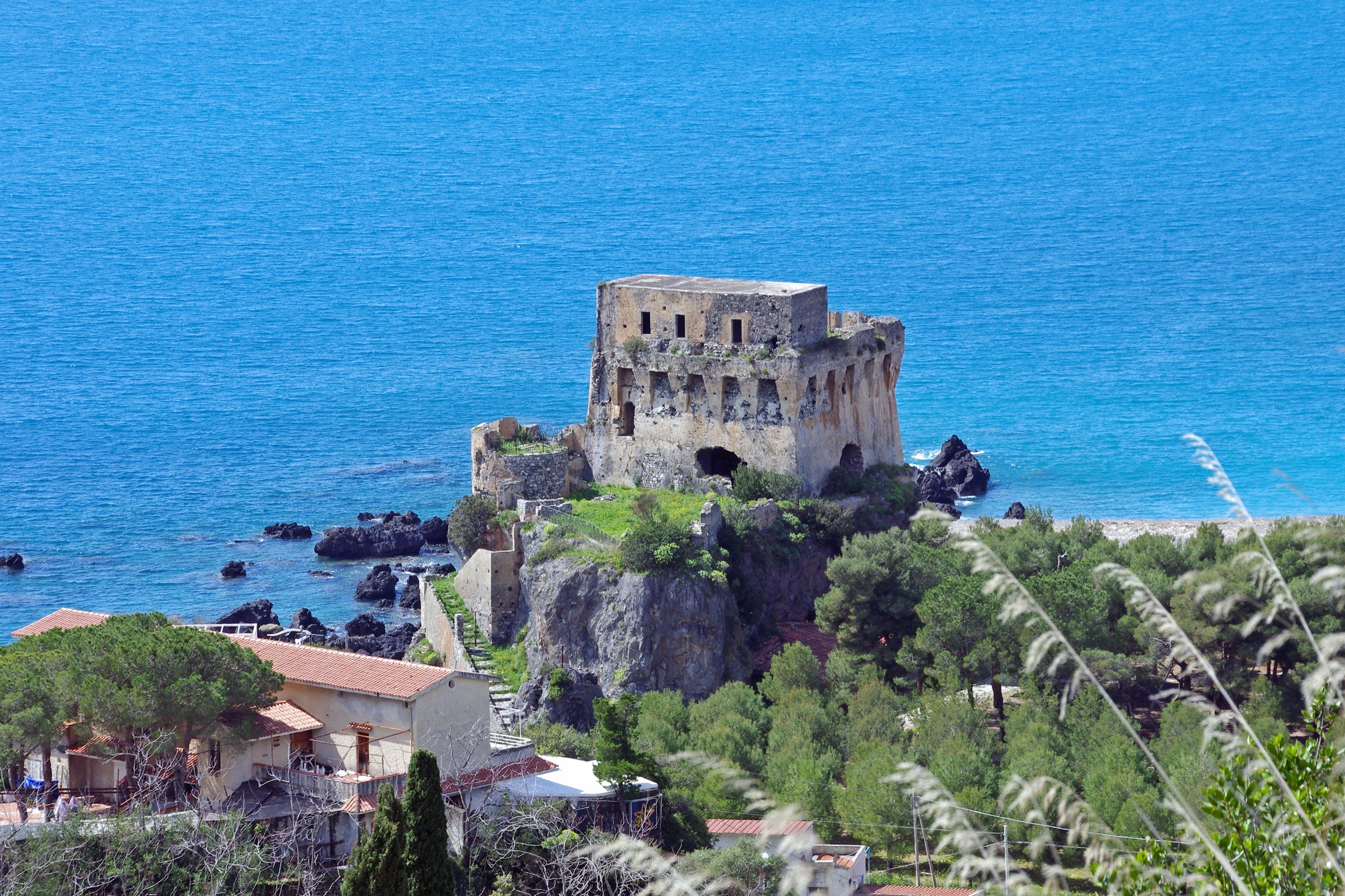 Ruins of a stone tower on a rocky coast in Praia a Mare, Calabria, Italy HD Wallpaper