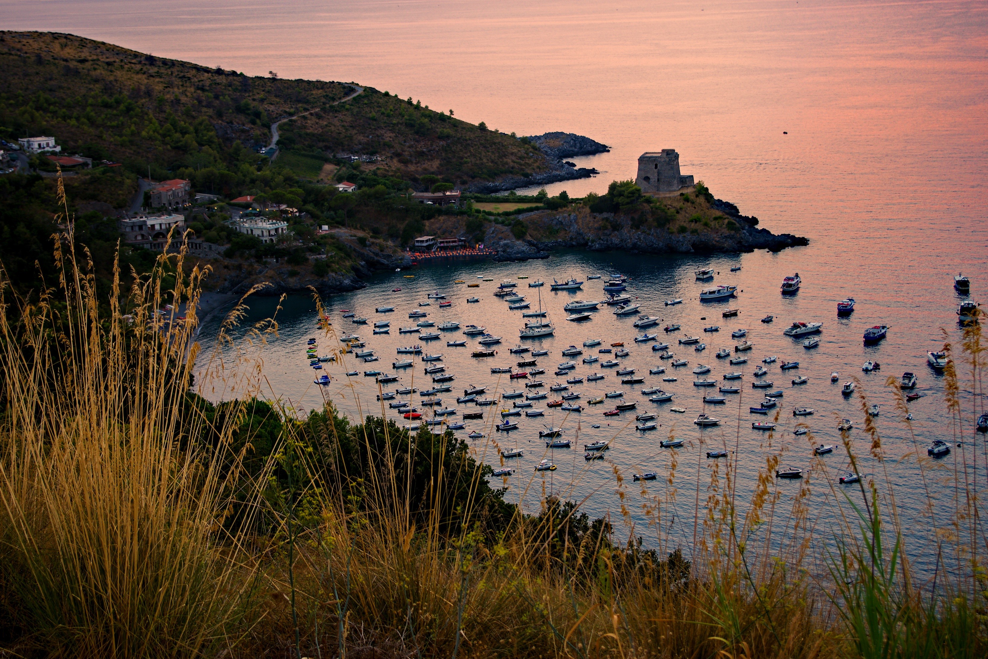 Boats in a bay with a tower in Calabria, Italy HD Wallpaper
