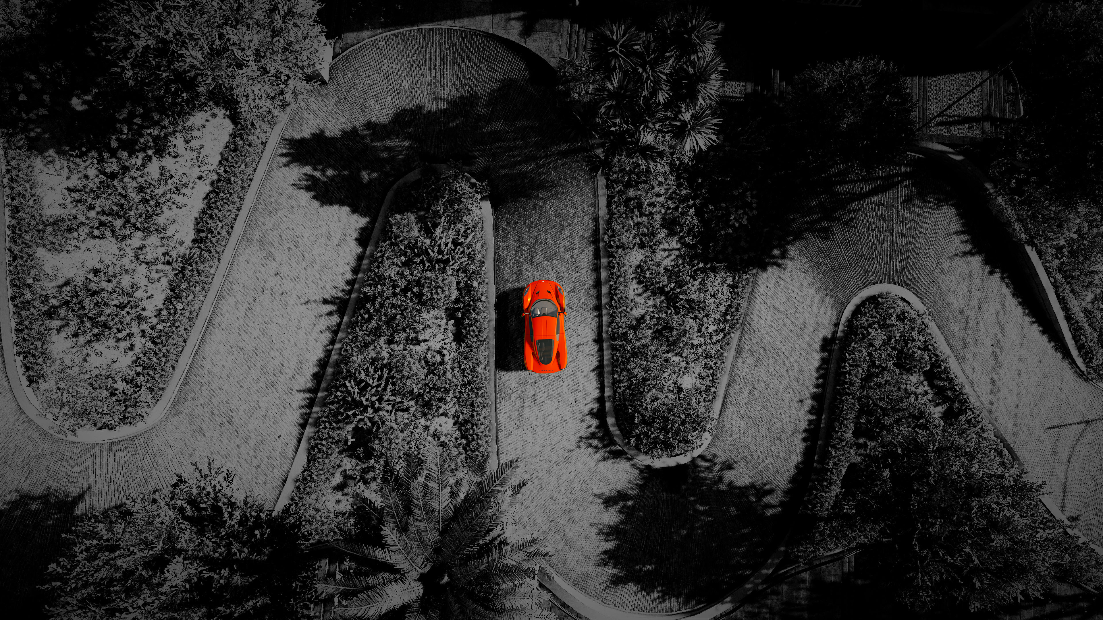 Orange Chevrolet Corvette C8 on a winding road HD Wallpaper