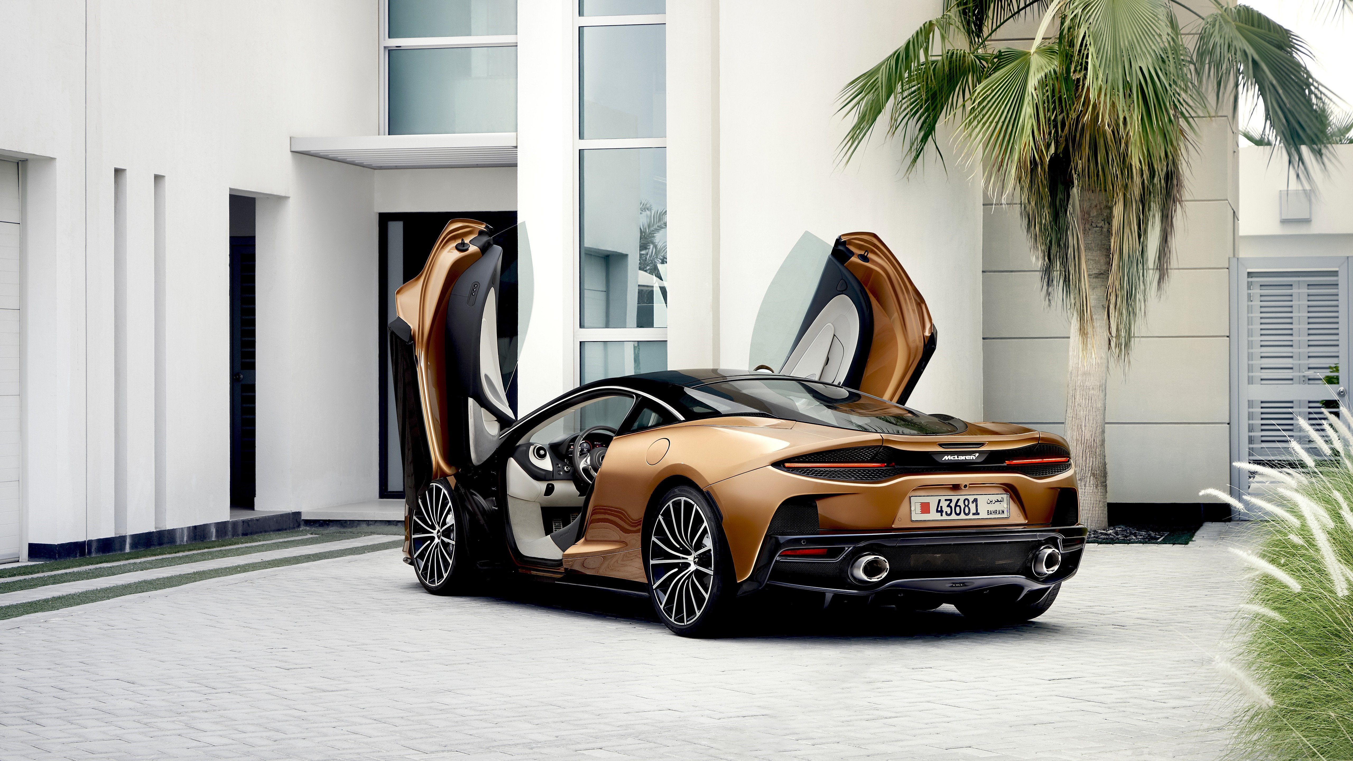 McLaren GT with Scissor Doors in Front of Modern House HD Wallpaper
