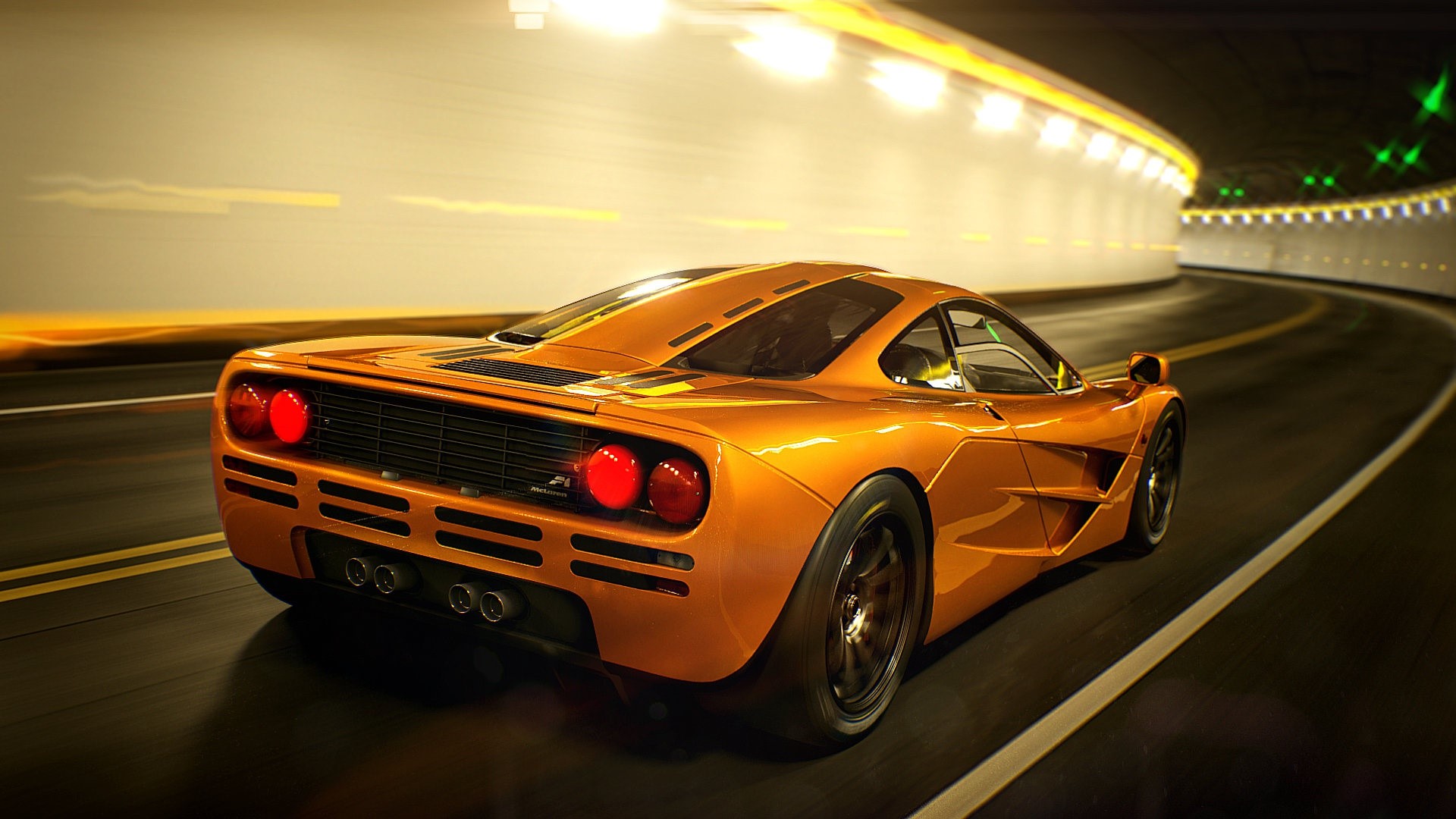 Orange McLaren F1 driving through a tunnel HD Wallpaper