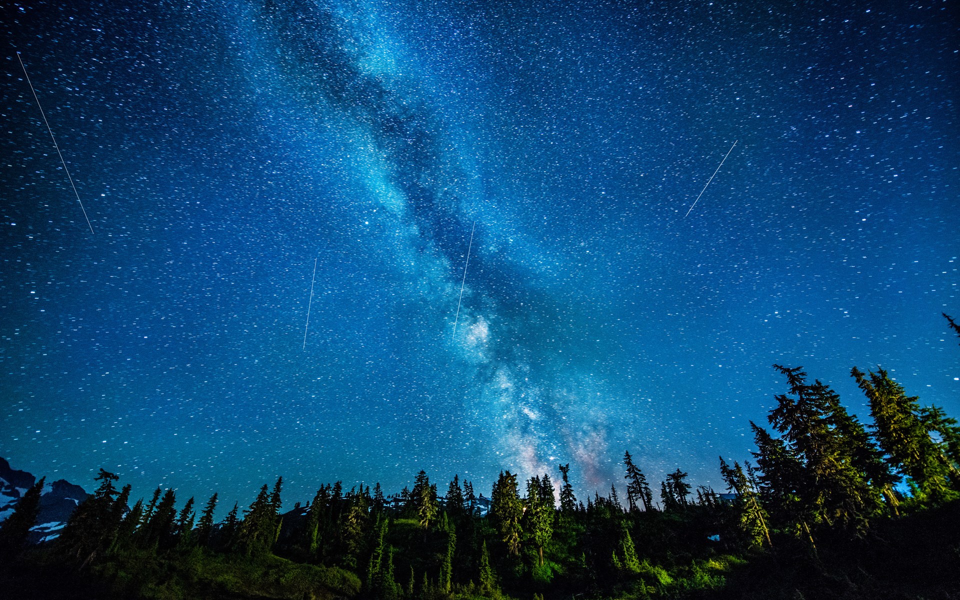 Milky Way galaxy over a forest and mountains HD Wallpaper