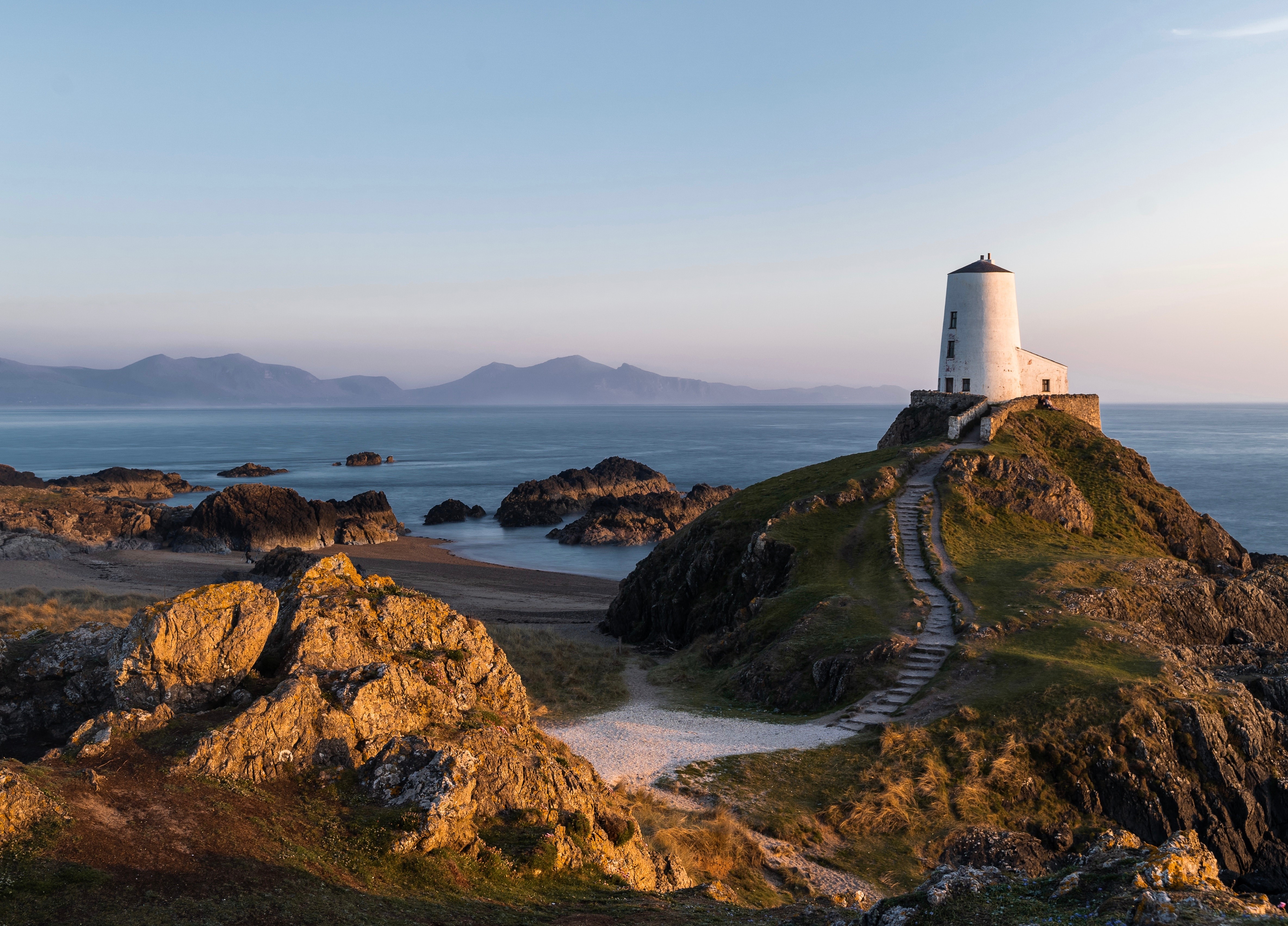 4K landscape of a lighthouse on a rocky coast HD Wallpaper