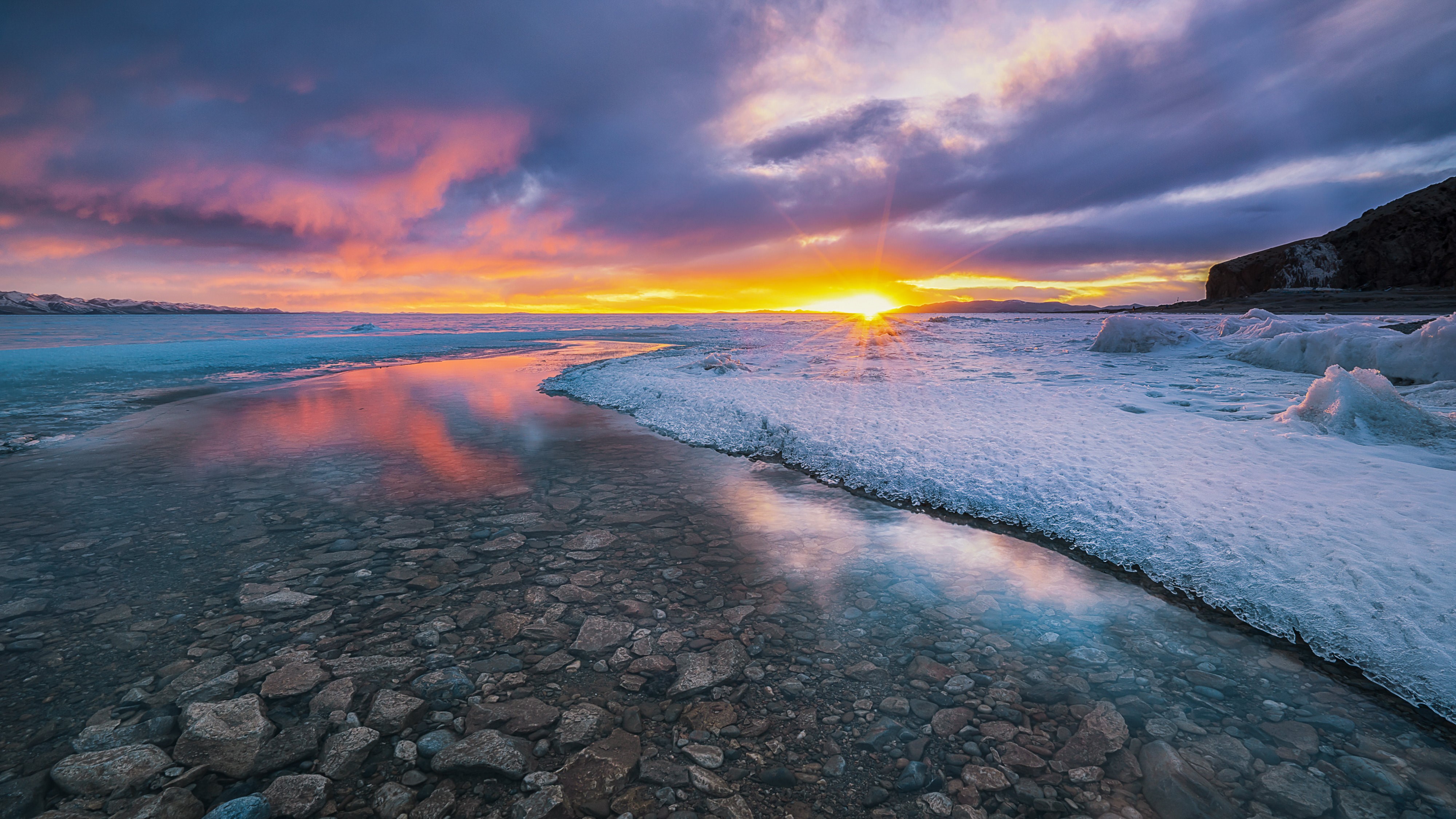 4K Sunrise over Icy Shoreline with Rocks HD Wallpaper