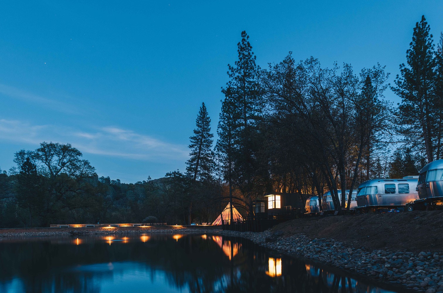 Airstream trailers and tent by a lake at dusk HD Wallpaper