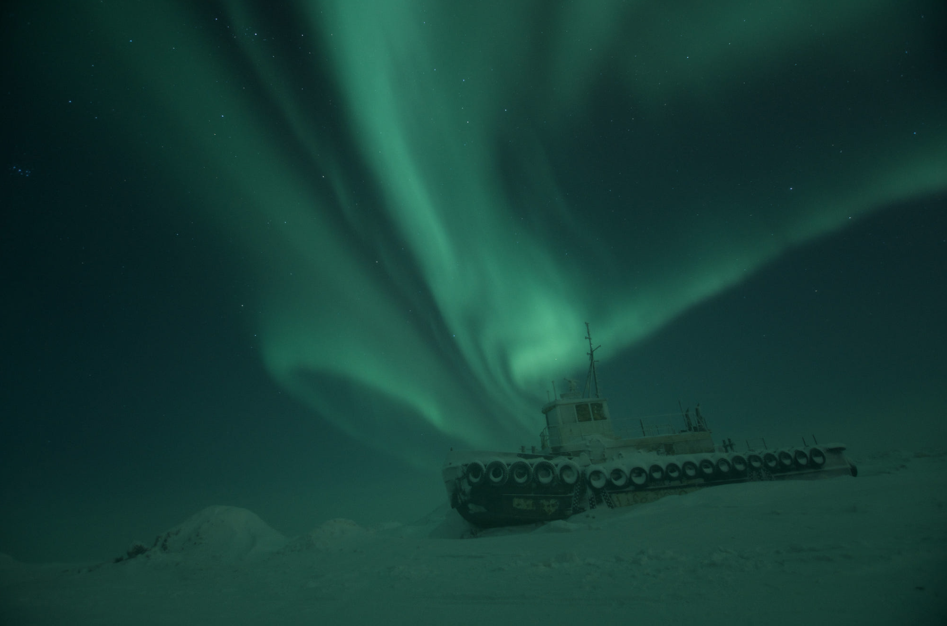 Abandoned tugboat under aurora borealis in Alaska HD Wallpaper