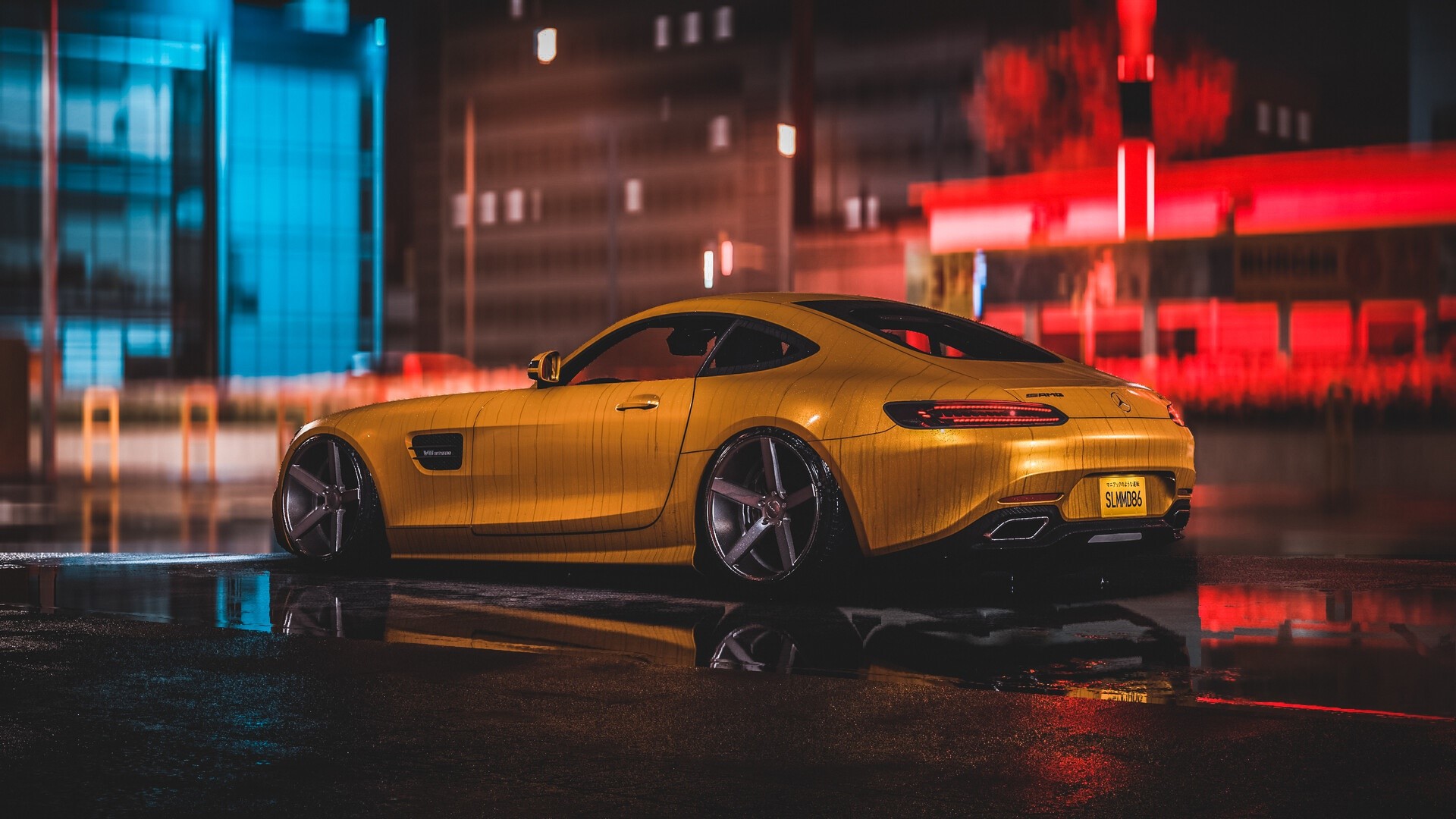 Yellow Mercedes-Benz AMG GT parked on wet city street at night HD Wallpaper