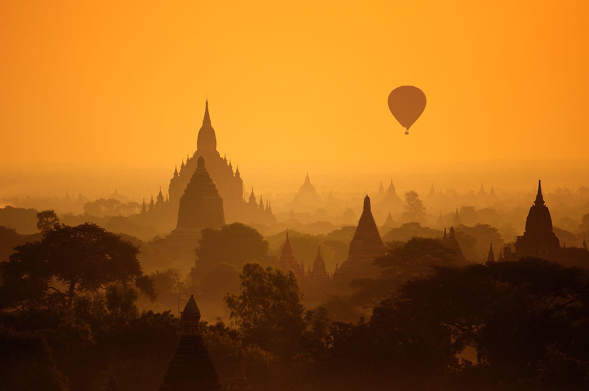 Hot air balloon over temples in Bagan, Myanmar at sunrise HD Wallpaper