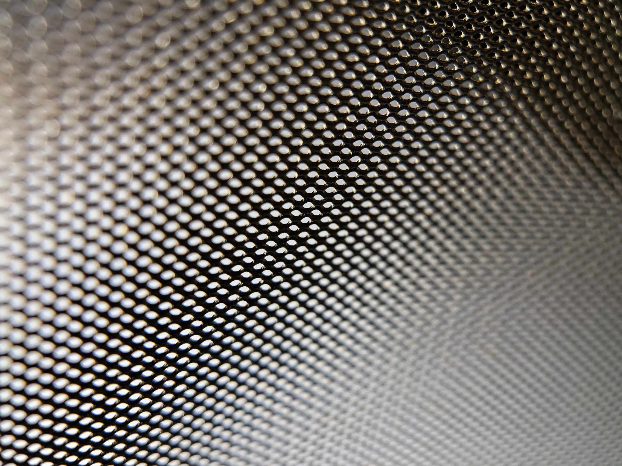 Close-up of a metallic mesh with bokeh effect HD Wallpaper