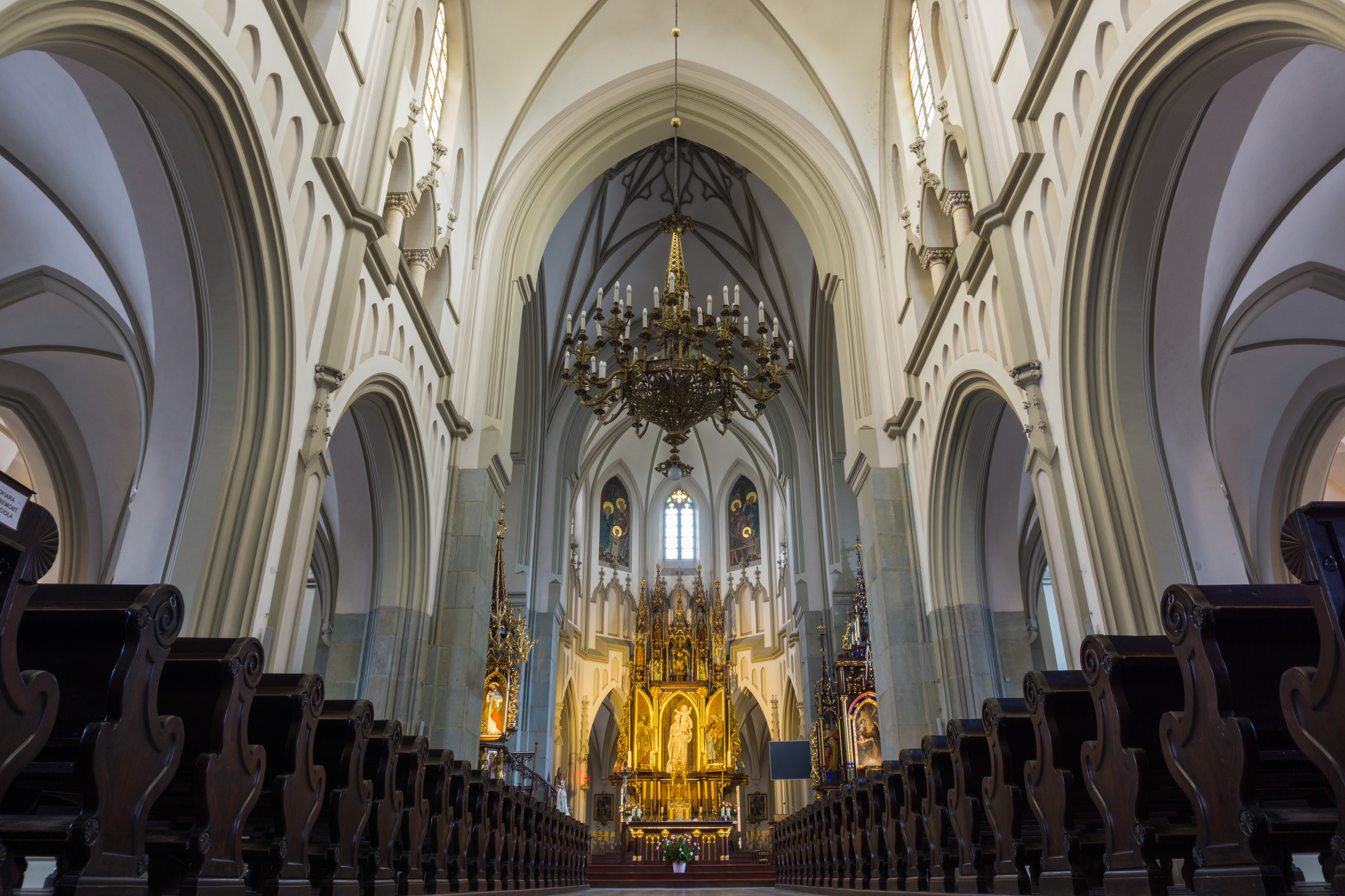 Interior of a grand church with pews and altar HD Wallpaper