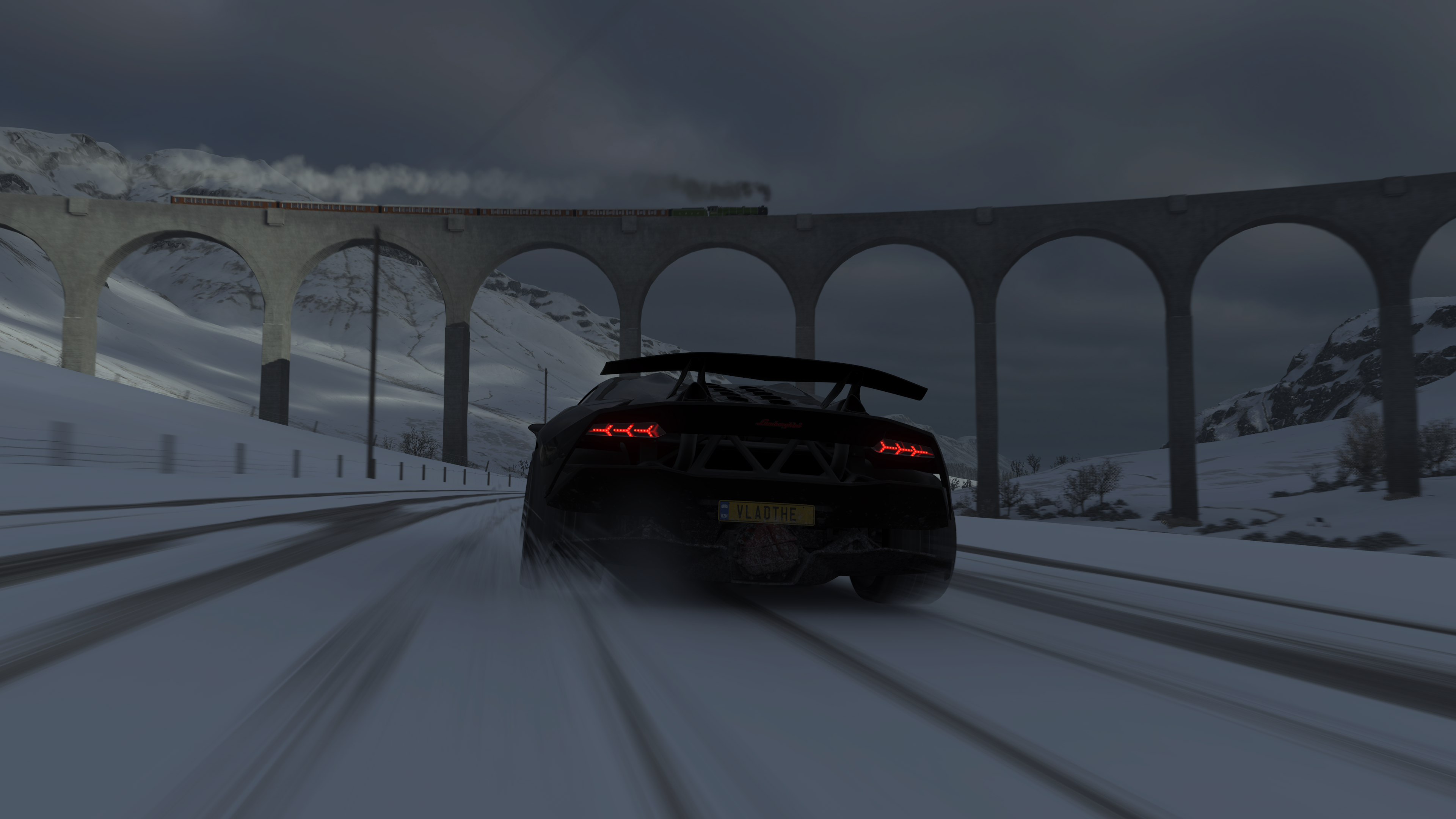 Black Lamborghini driving on snowy road with train bridge HD Wallpaper