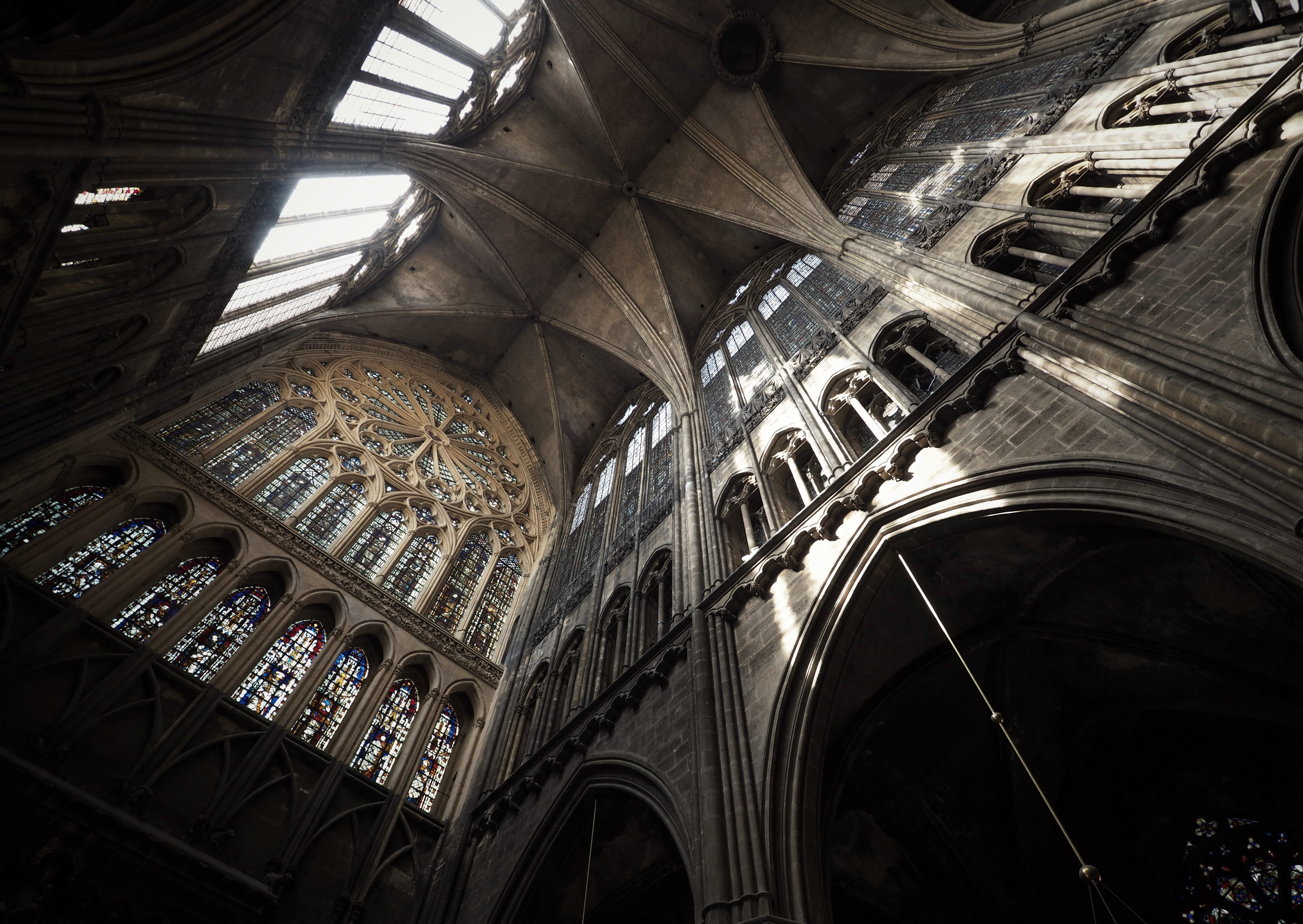 Cathedral interior with stained glass windows and vaulted ceiling HD Wallpaper