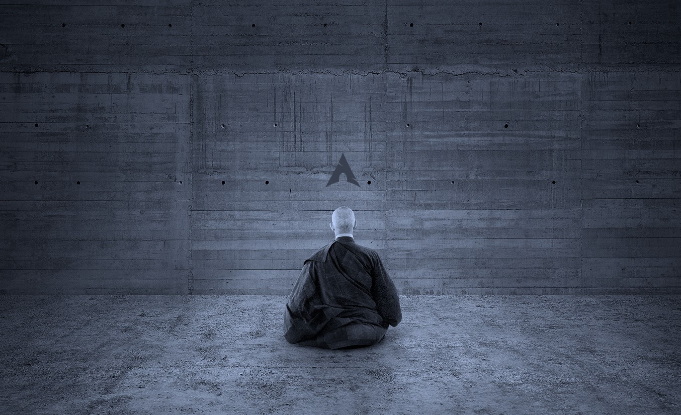 Man meditating in front of Arch Linux logo on concrete wall HD Wallpaper