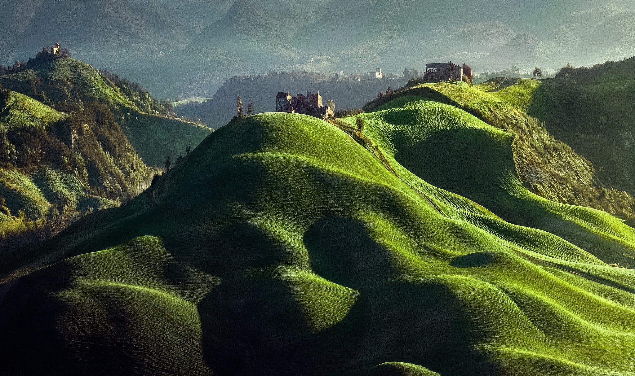 Rolling green hills with ancient ruins HD Wallpaper