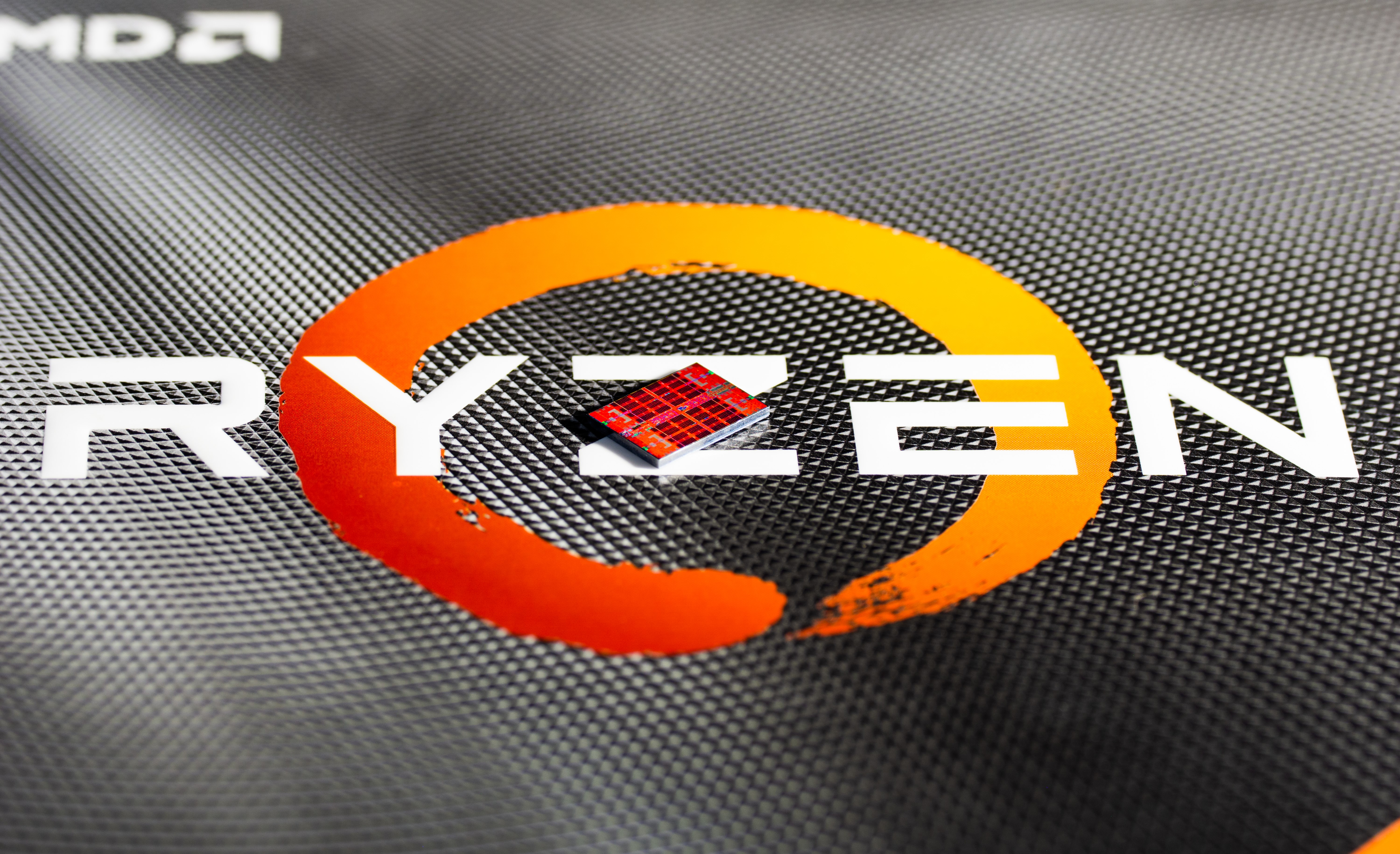 AMD RYZEN CPU integrated circuit on a textured surface HD Wallpaper