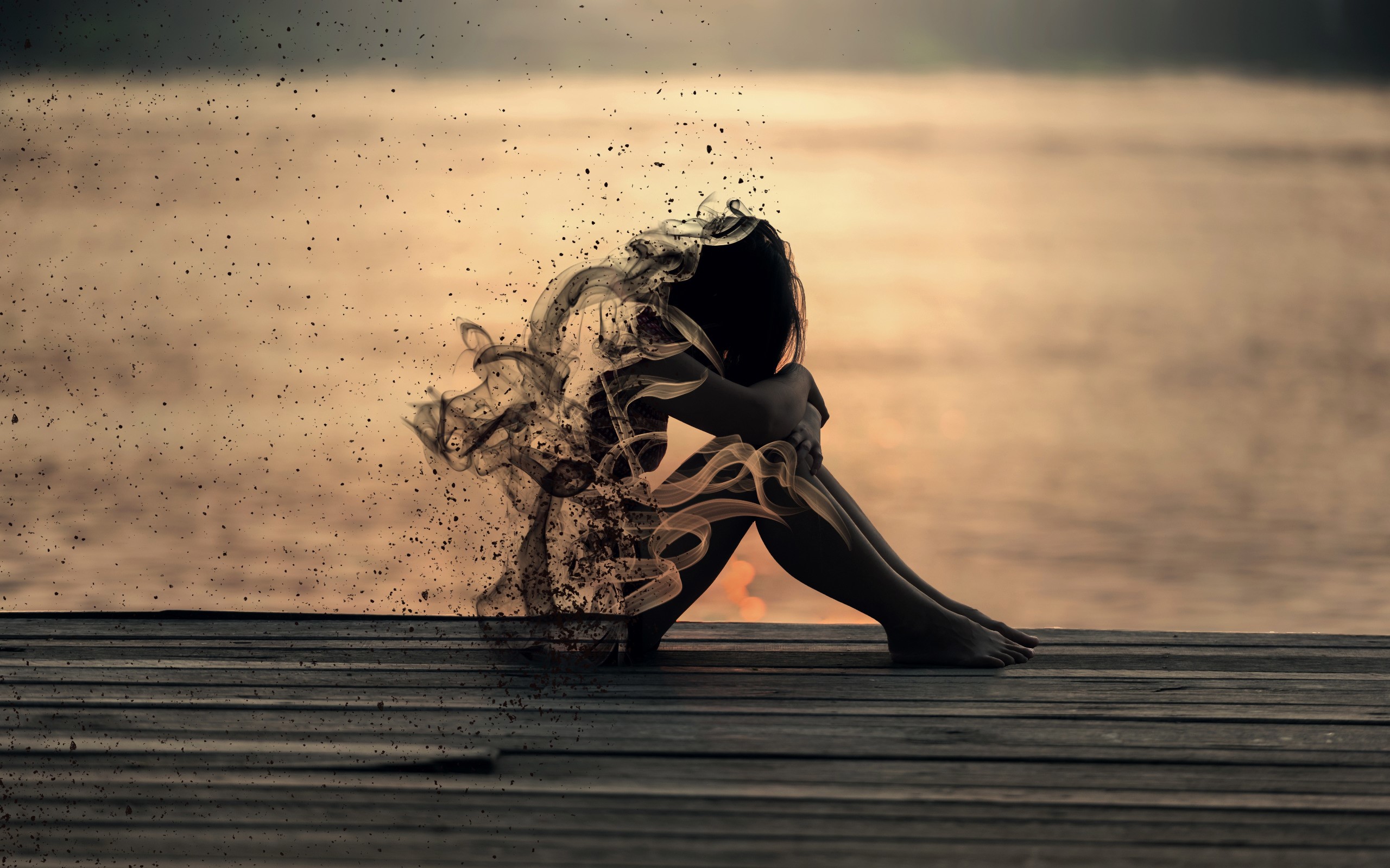 Woman dissolving into smoke and particles HD Wallpaper
