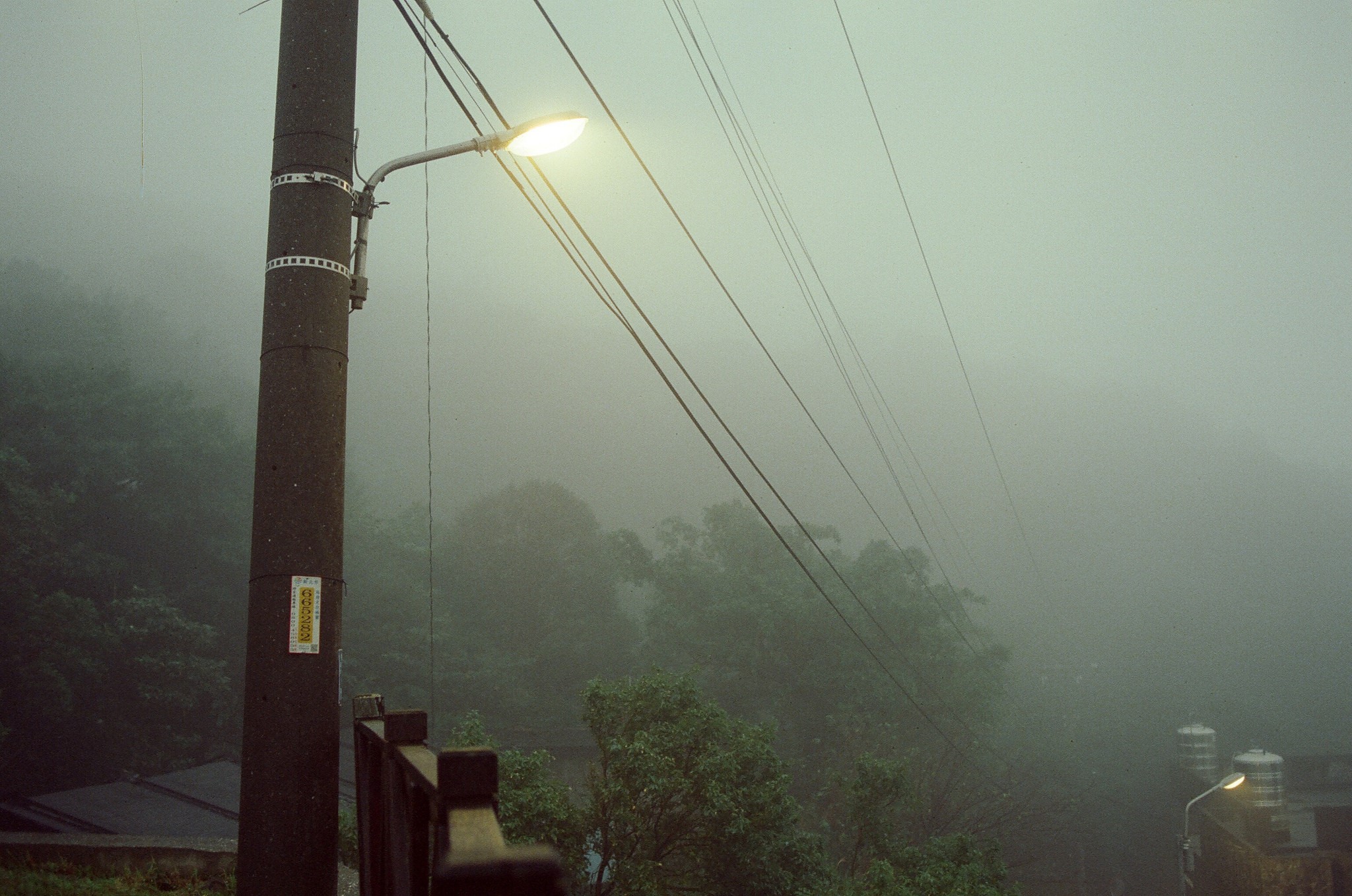 Street light and power lines in mist HD Wallpaper