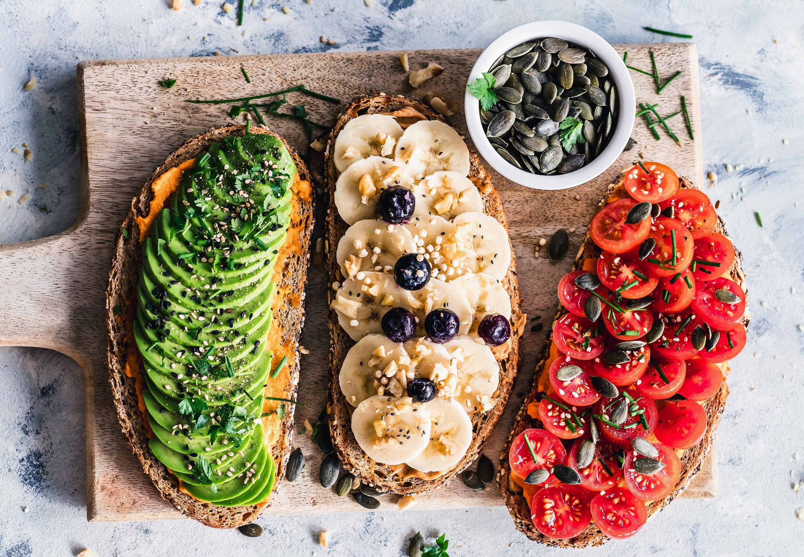 Avocado, banana, and tomato toasts with pumpkin seeds HD Wallpaper