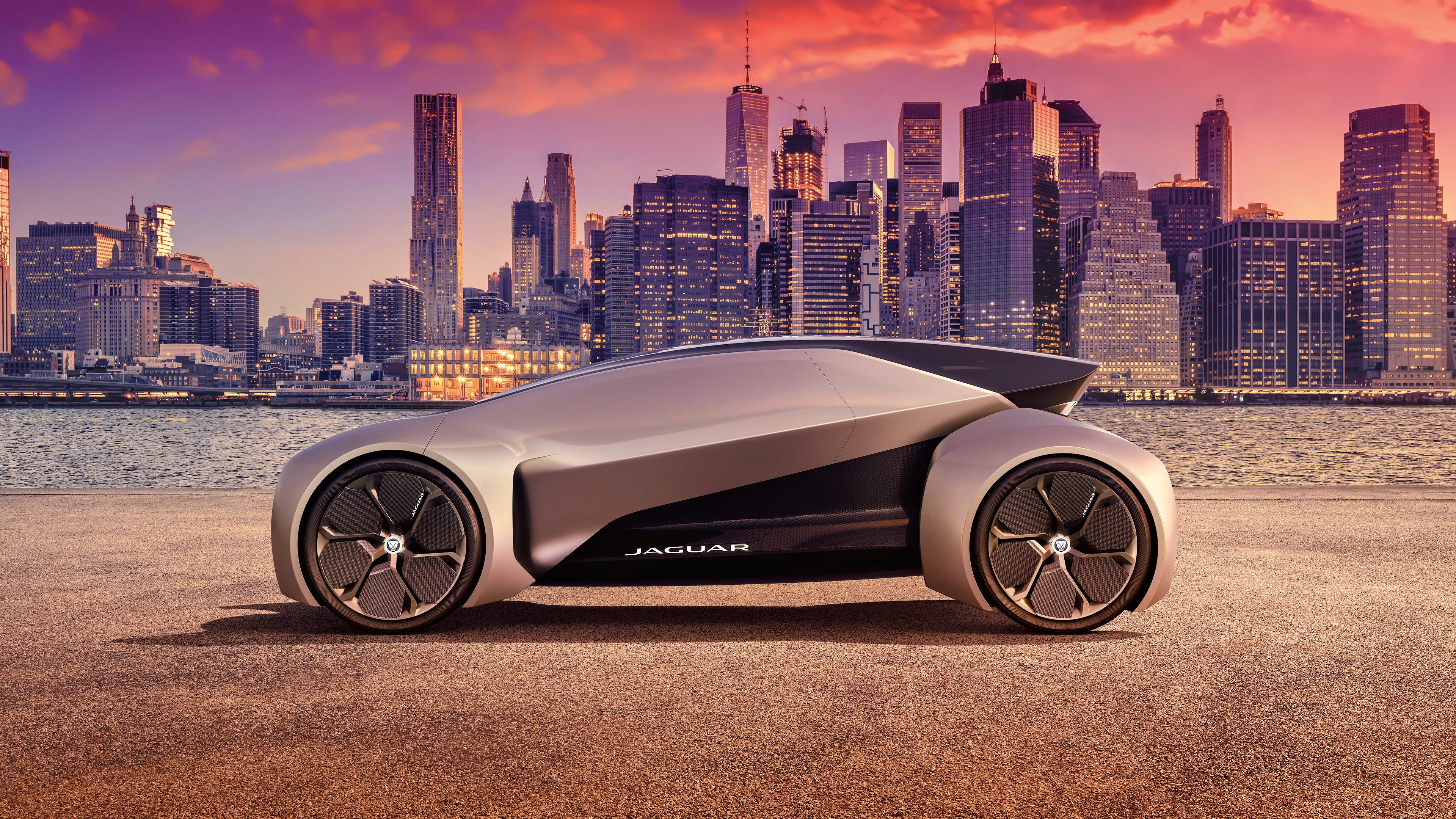 Futuristic Jaguar concept car in cityscape at sunset HD Wallpaper