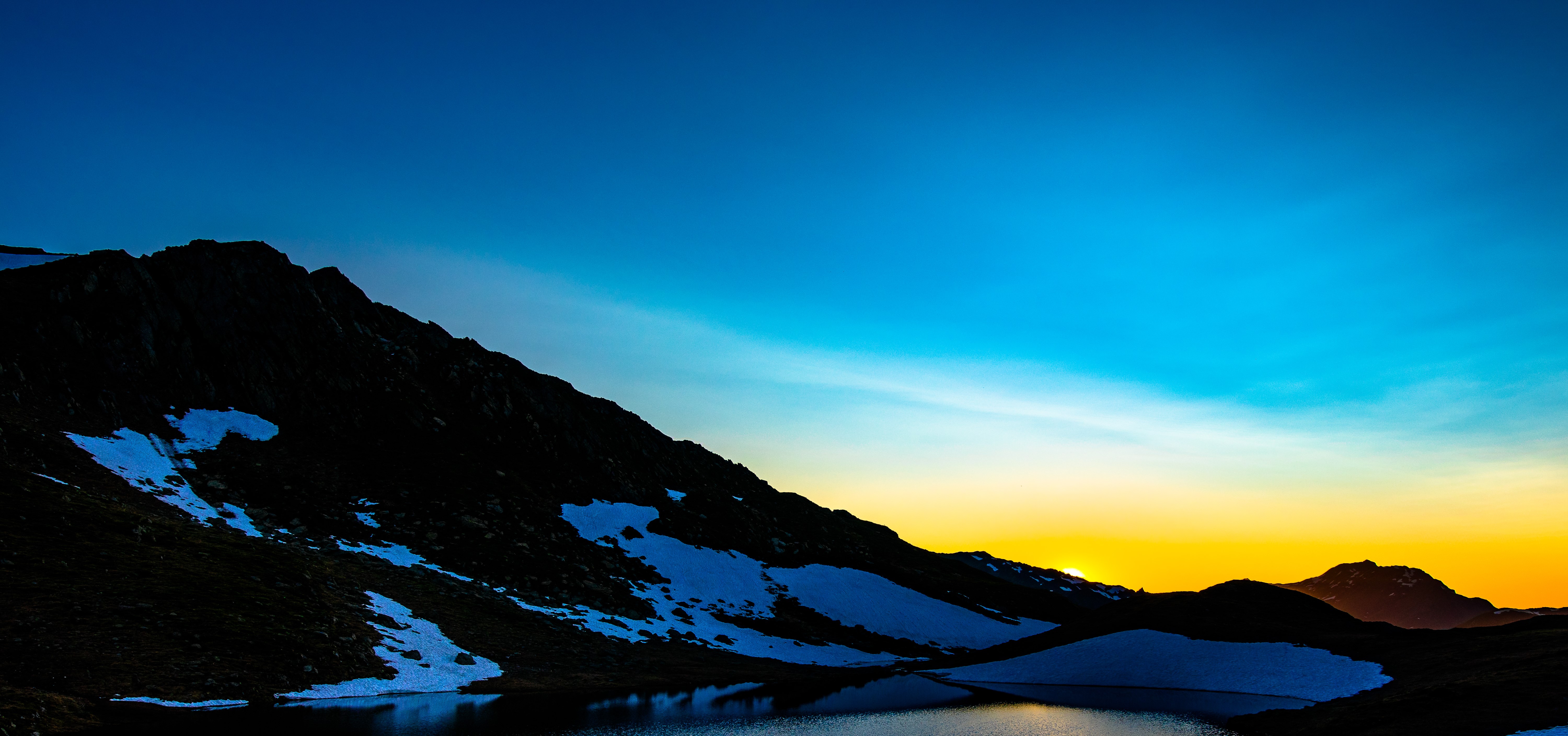 Mountains with snow and lake at sunset HD Wallpaper