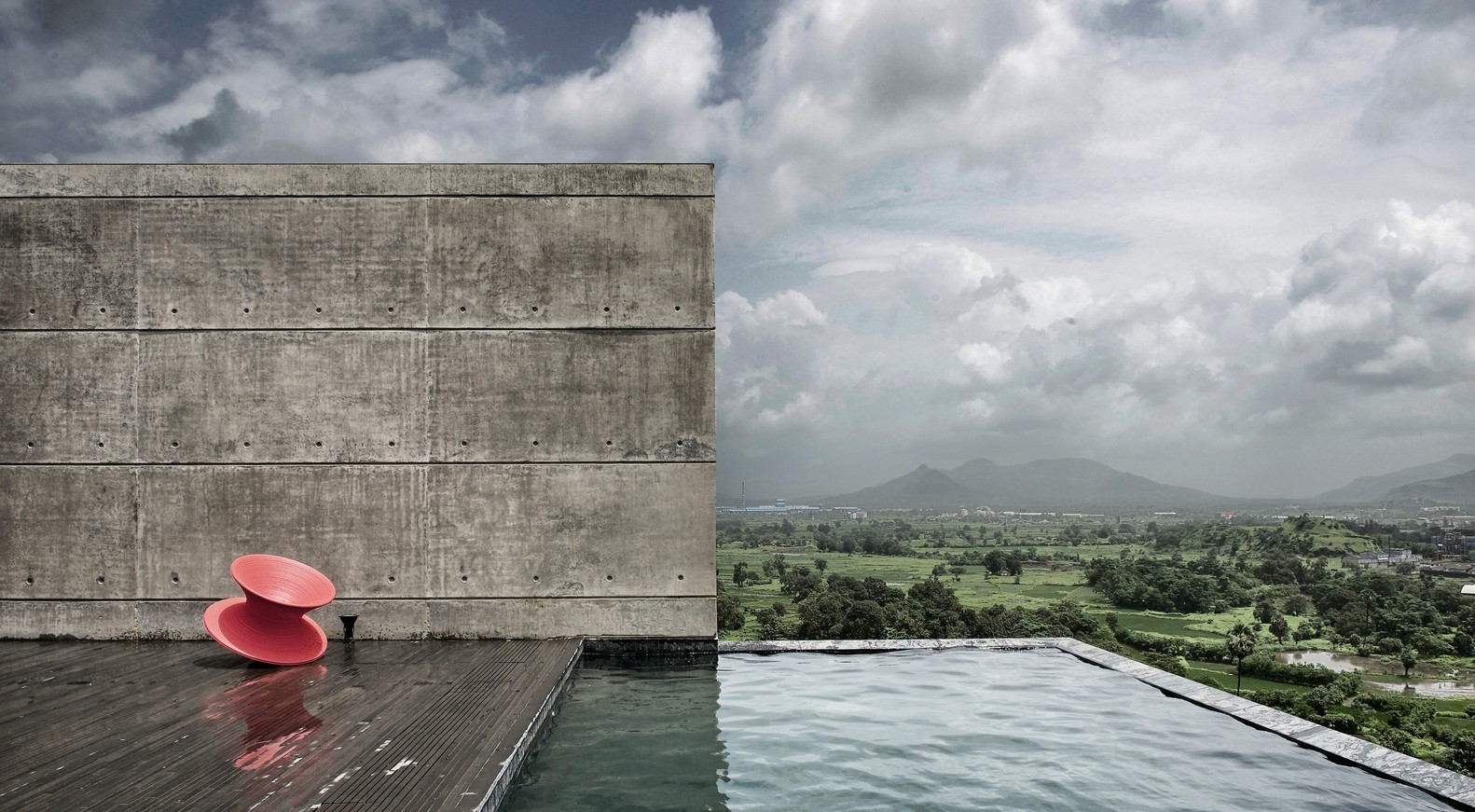 Concrete wall and infinity pool overlooking landscape HD Wallpaper