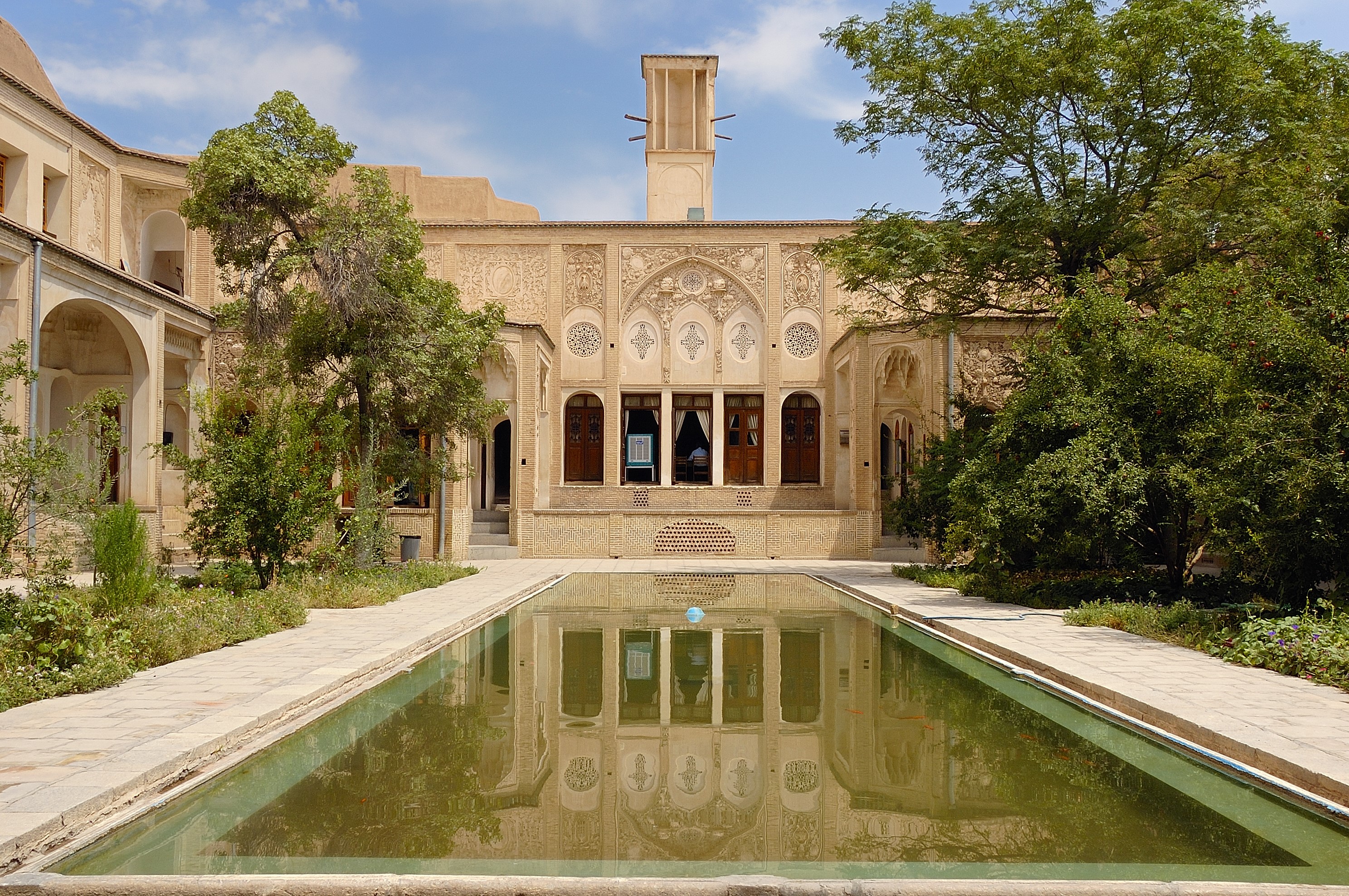 Traditional Persian courtyard with reflecting pool and windcatcher HD Wallpaper