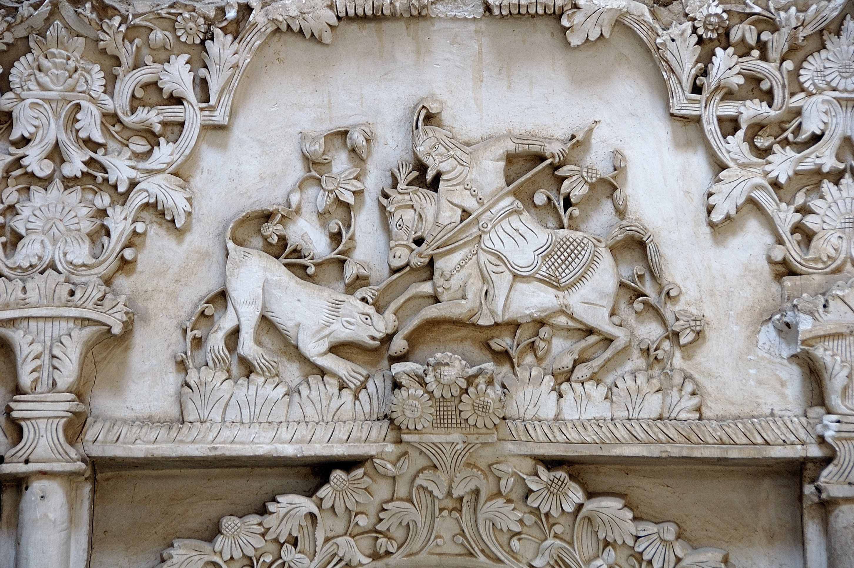Bas-relief carving of a man on horseback fighting a lion in Iran HD Wallpaper
