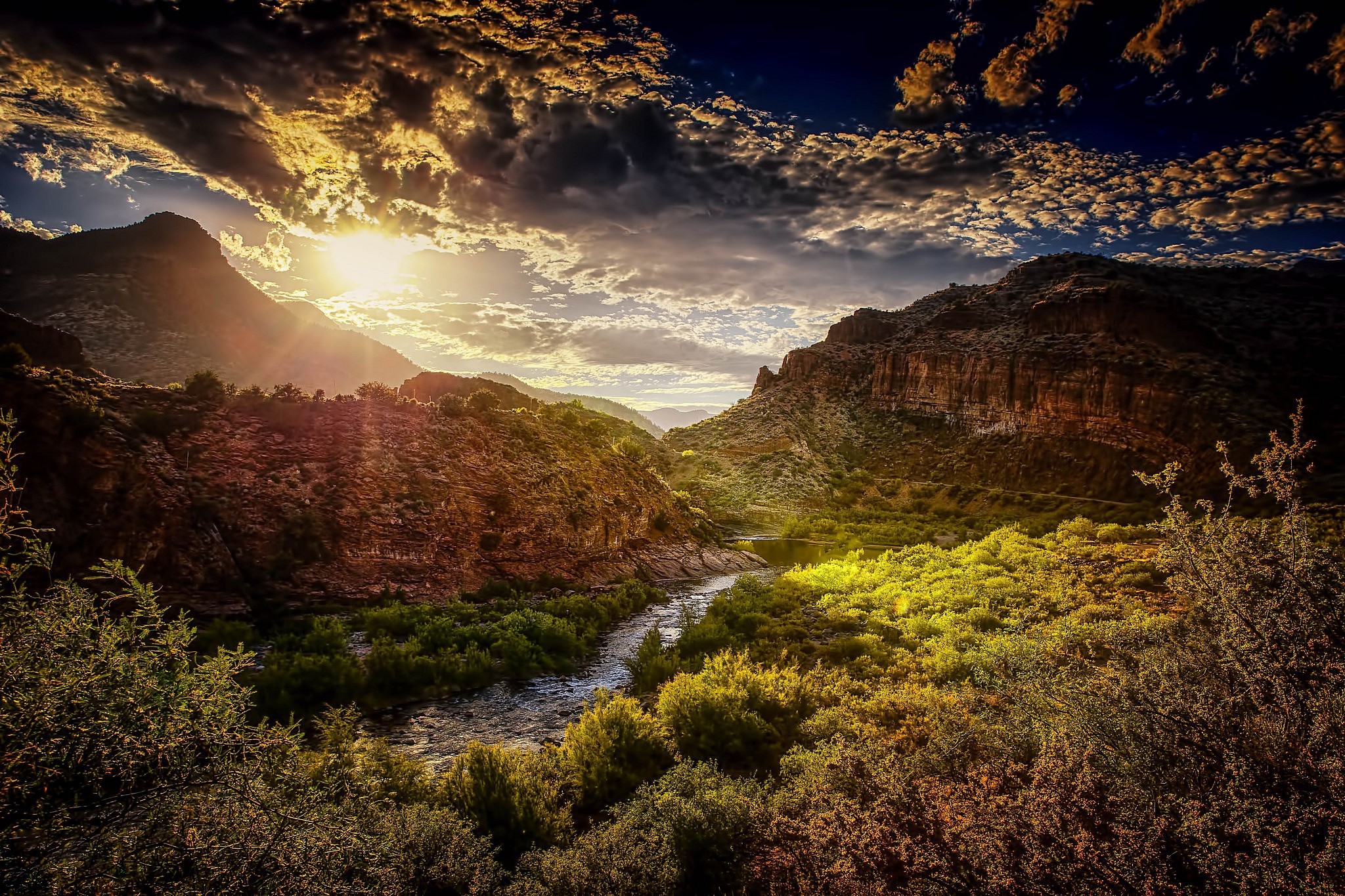 River flowing through a canyon at sunset HD Wallpaper