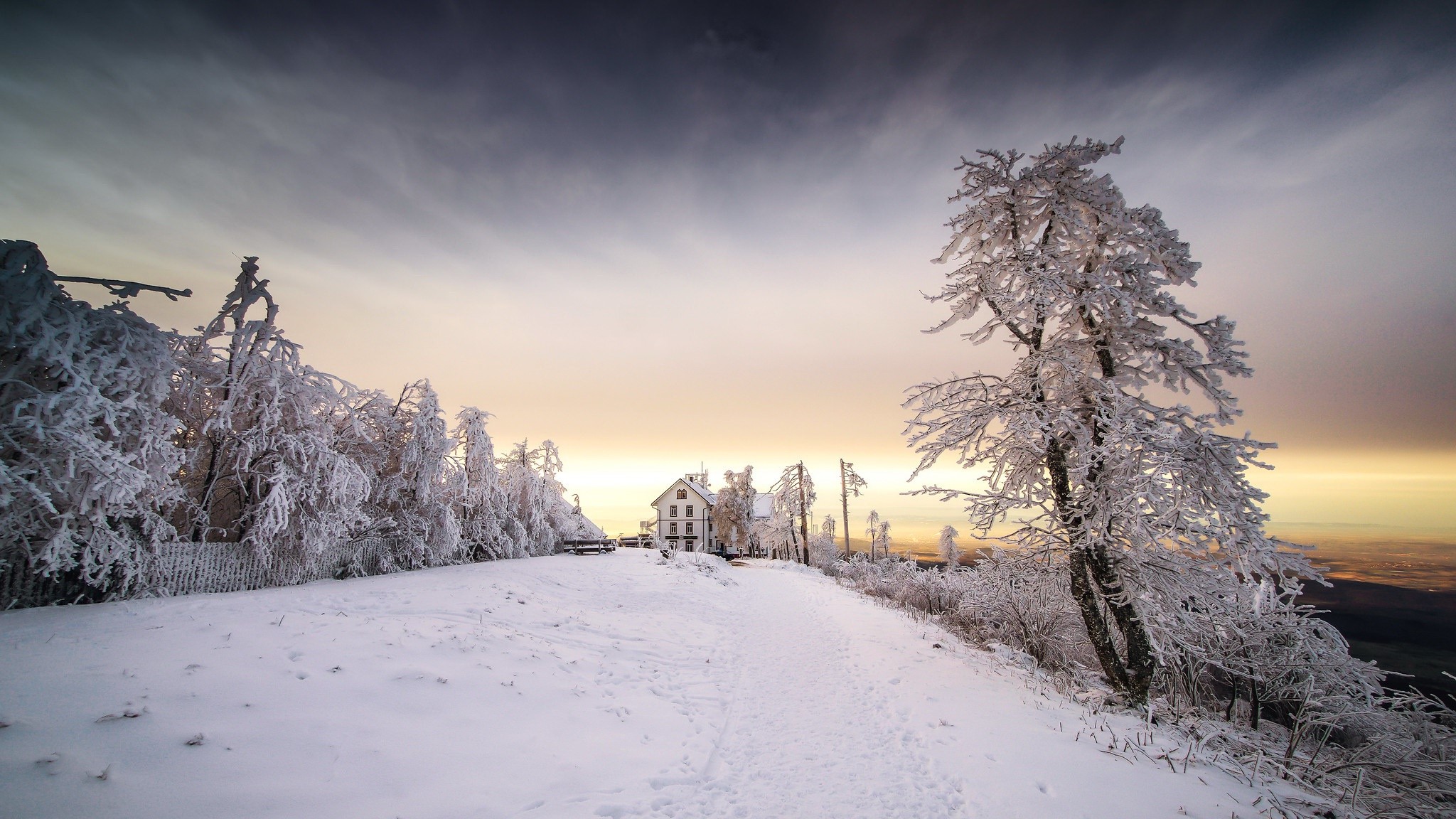 Snow-covered trees and buildings on a winter mountain HD Wallpaper