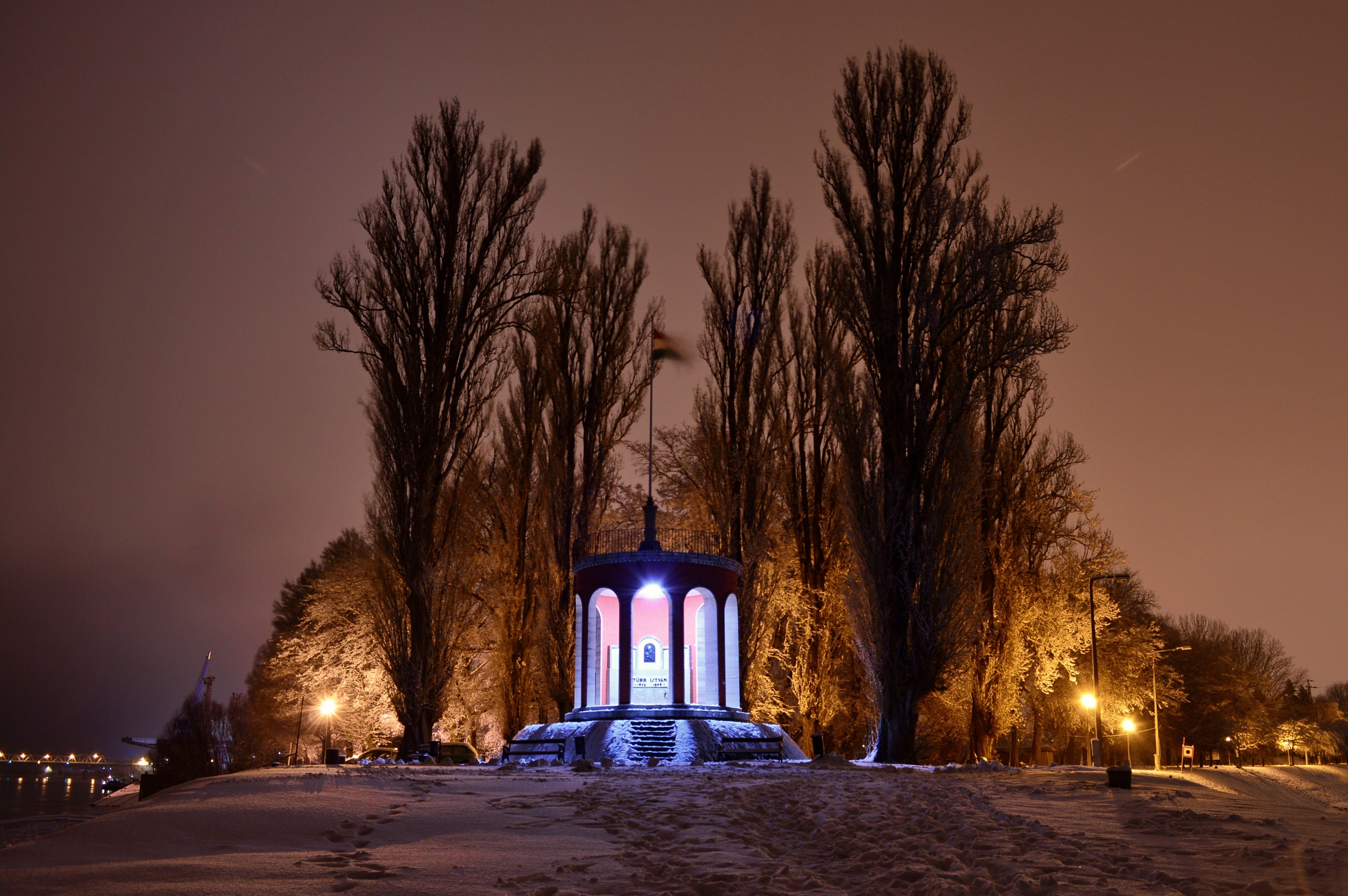 Winter night in Hungary with snow and a monument HD Wallpaper