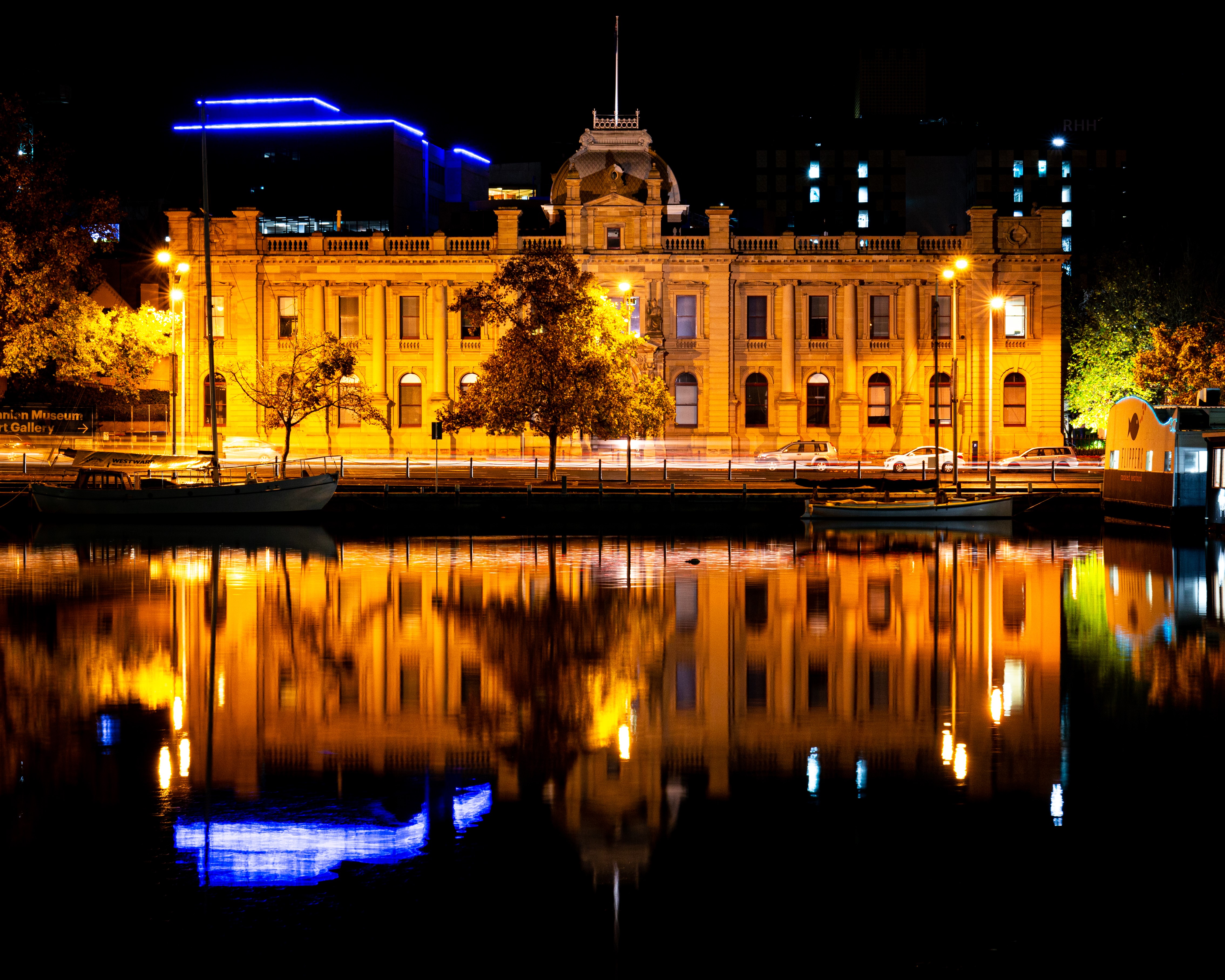 Old building reflected in water at night HD Wallpaper